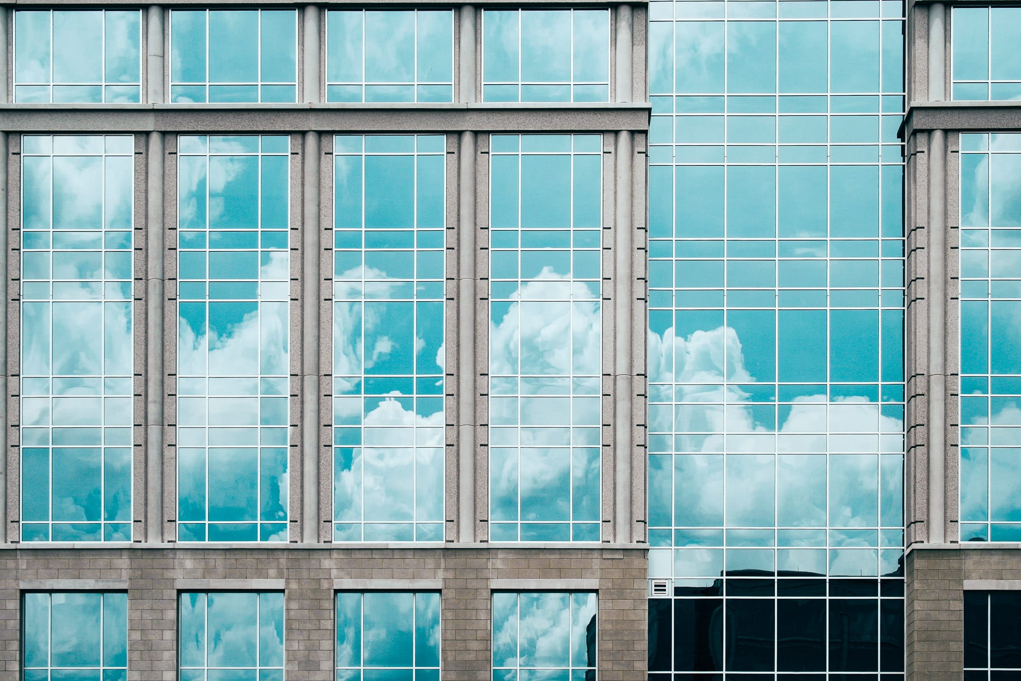 Clouds reflected in the windows of an office building in Frisco, Texas.