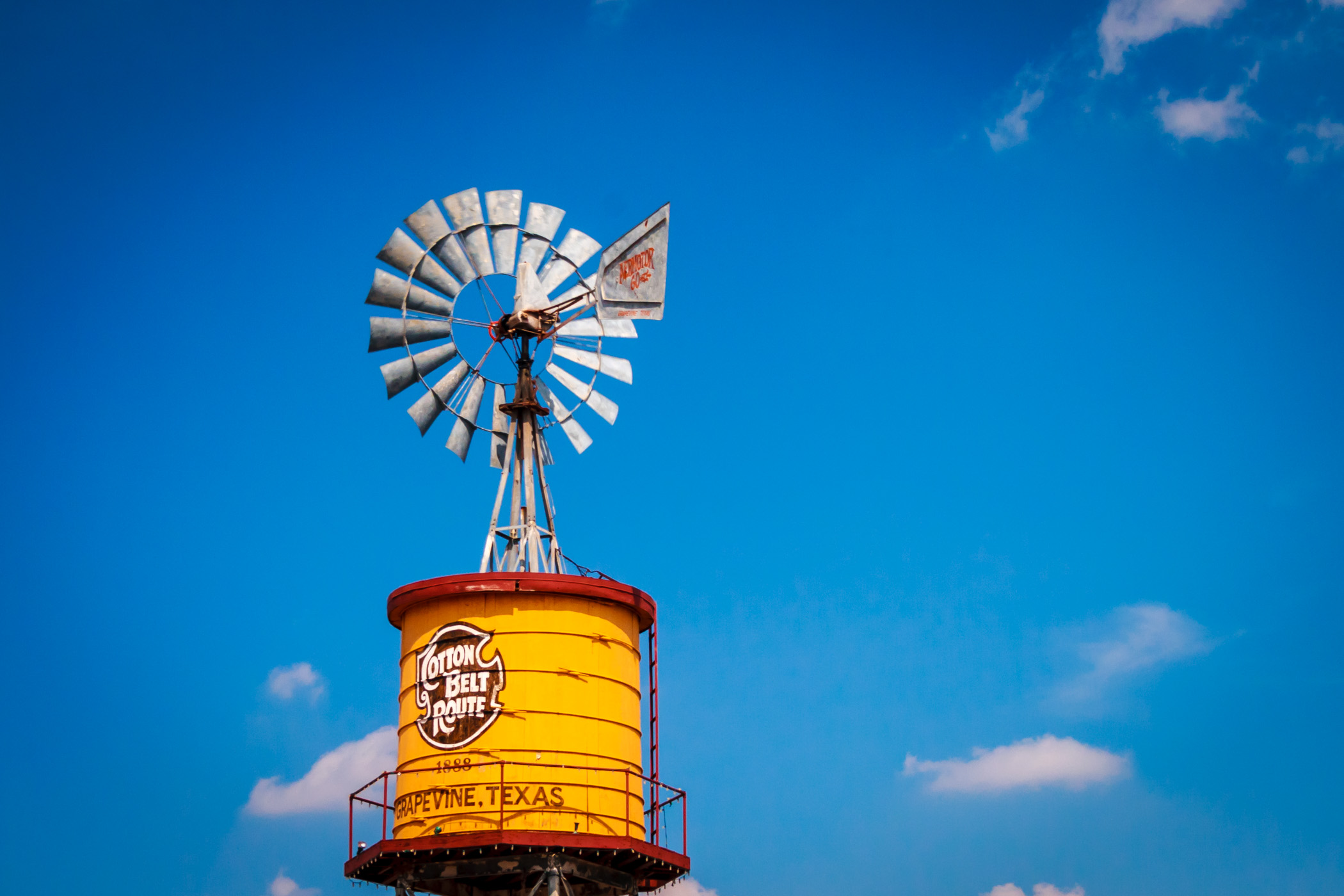 A vintage Cotton Belt Route Aeromotor-brand windmill atop a water tower in Grapevine, Texas.