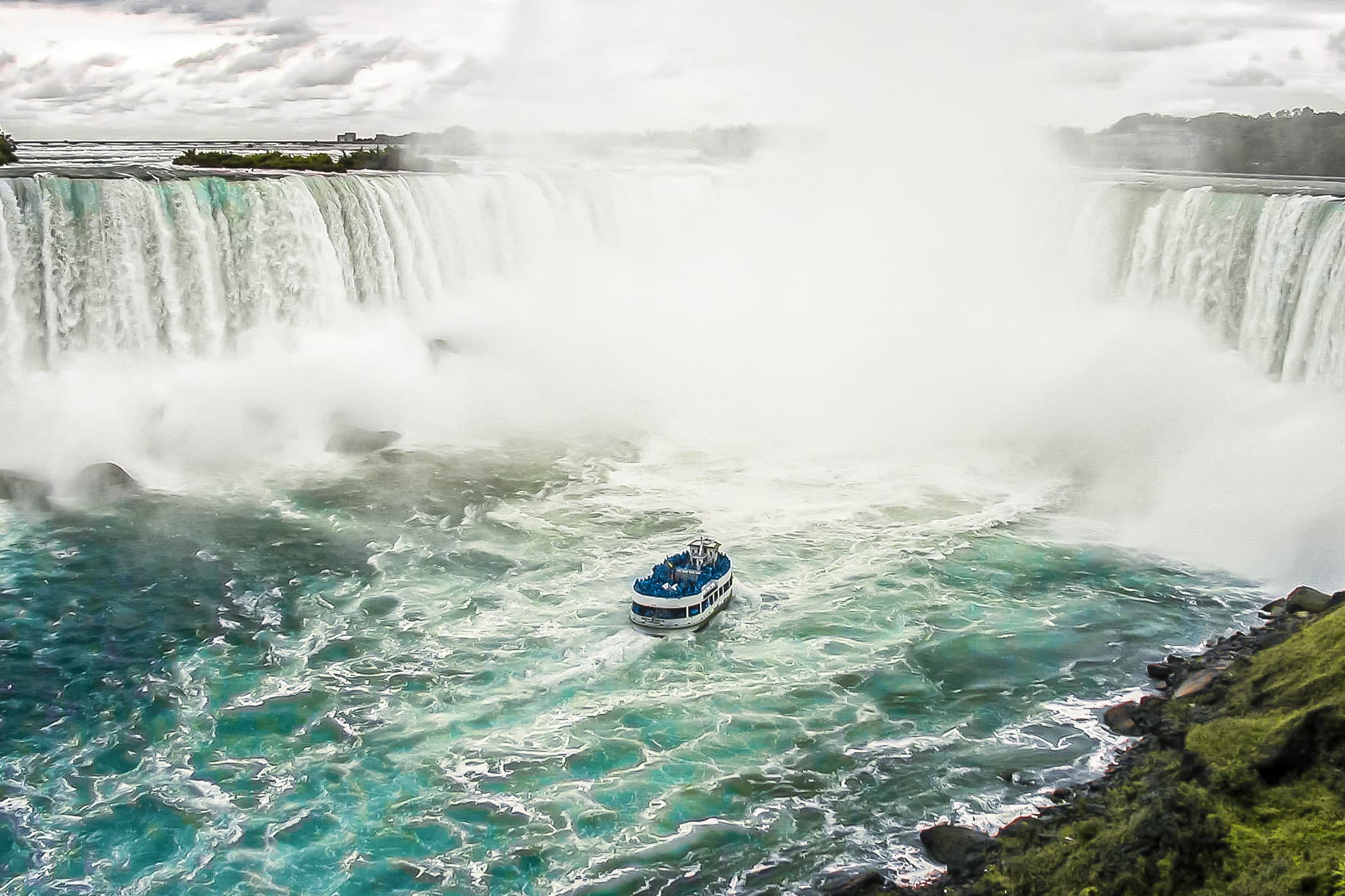 A Maid of The Mist tour boat braves the Canadian (Horseshoe) Falls at Niagara Falls, Ontario.