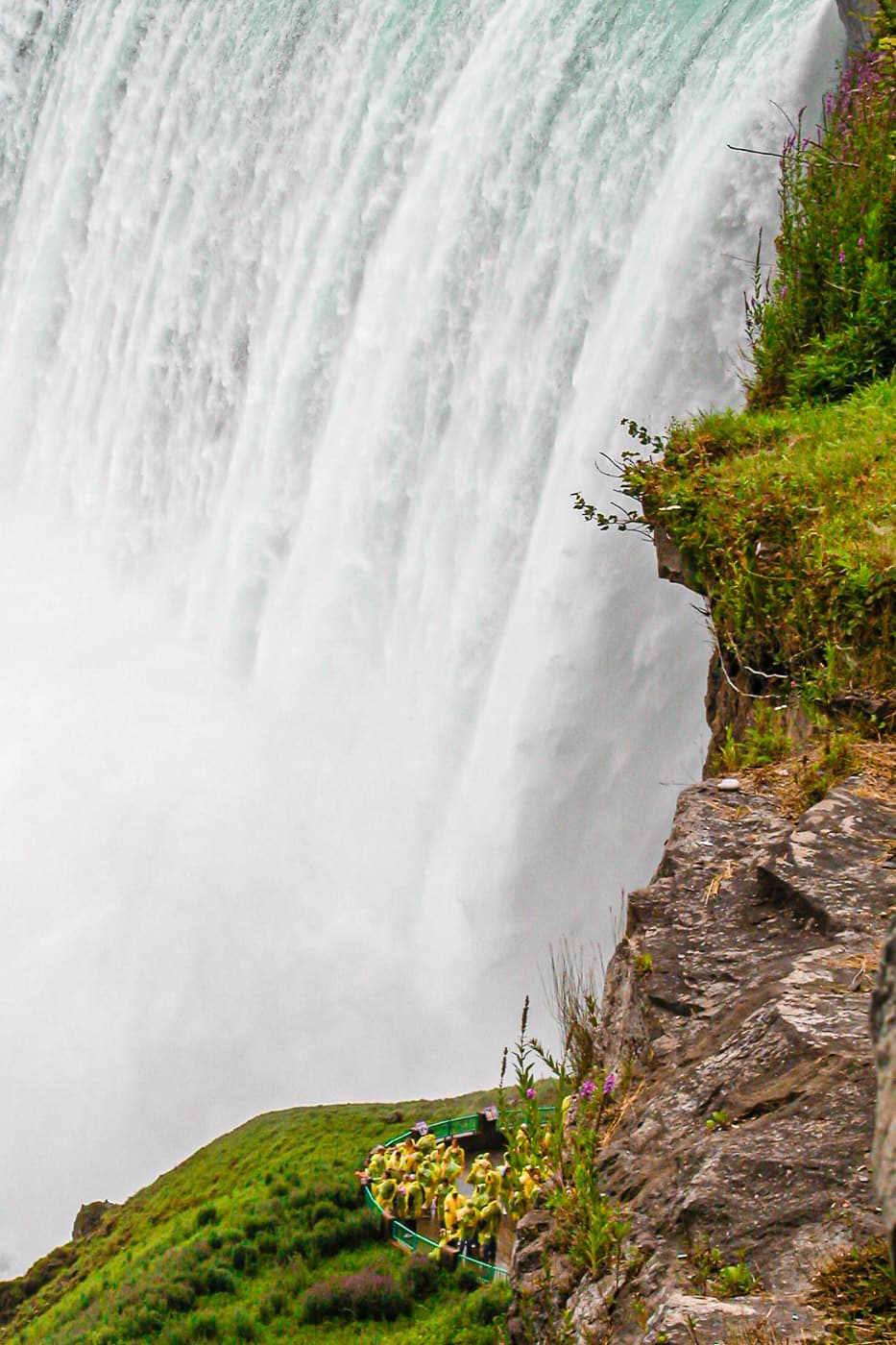 Tourists on the Journey Behind the Falls tour at Niagara are dwarfed by the Horseshoe (Canadian) Falls.