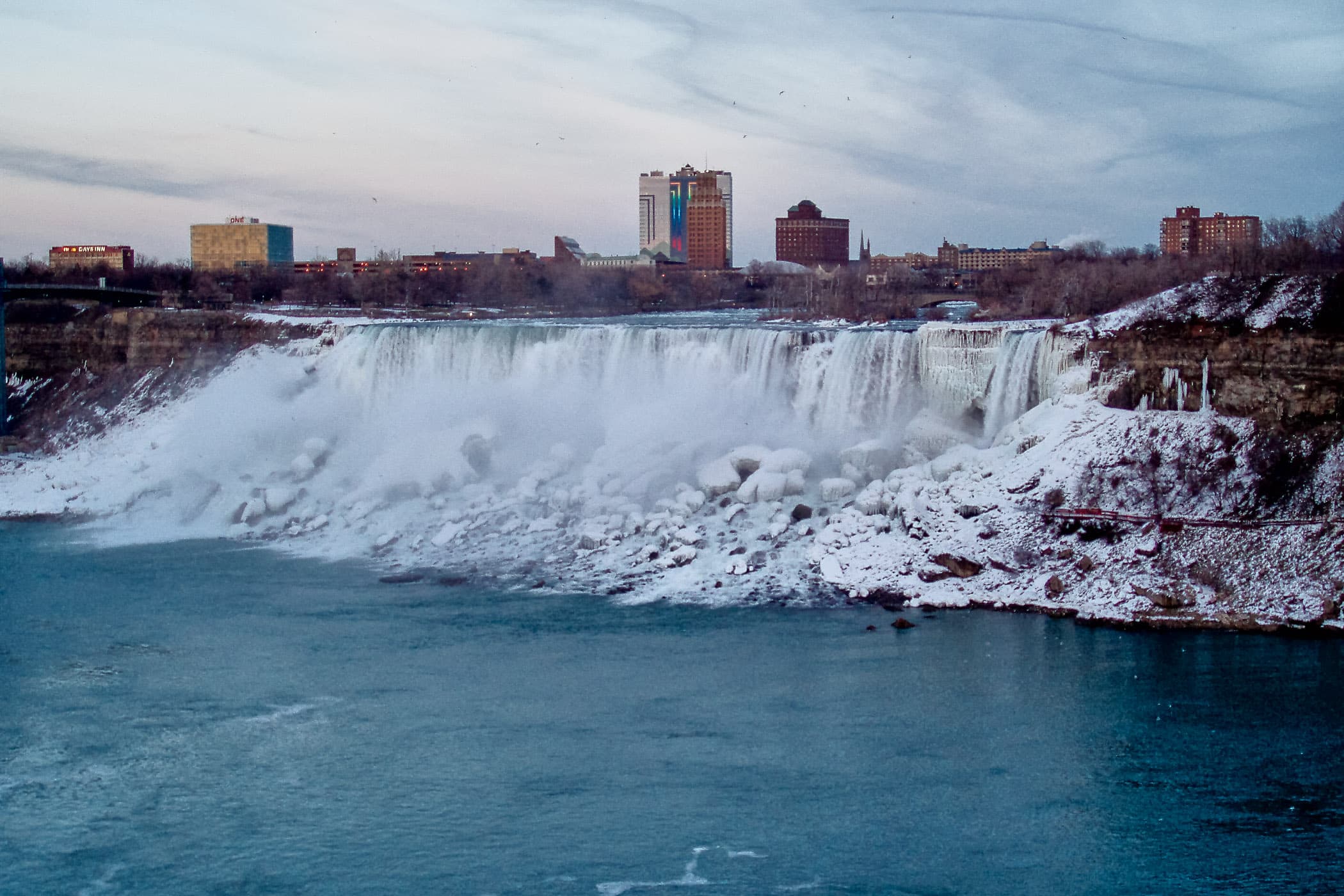 The American Falls at Niagara Falls as seen from the Canadian side of the border on a cold winter evening.