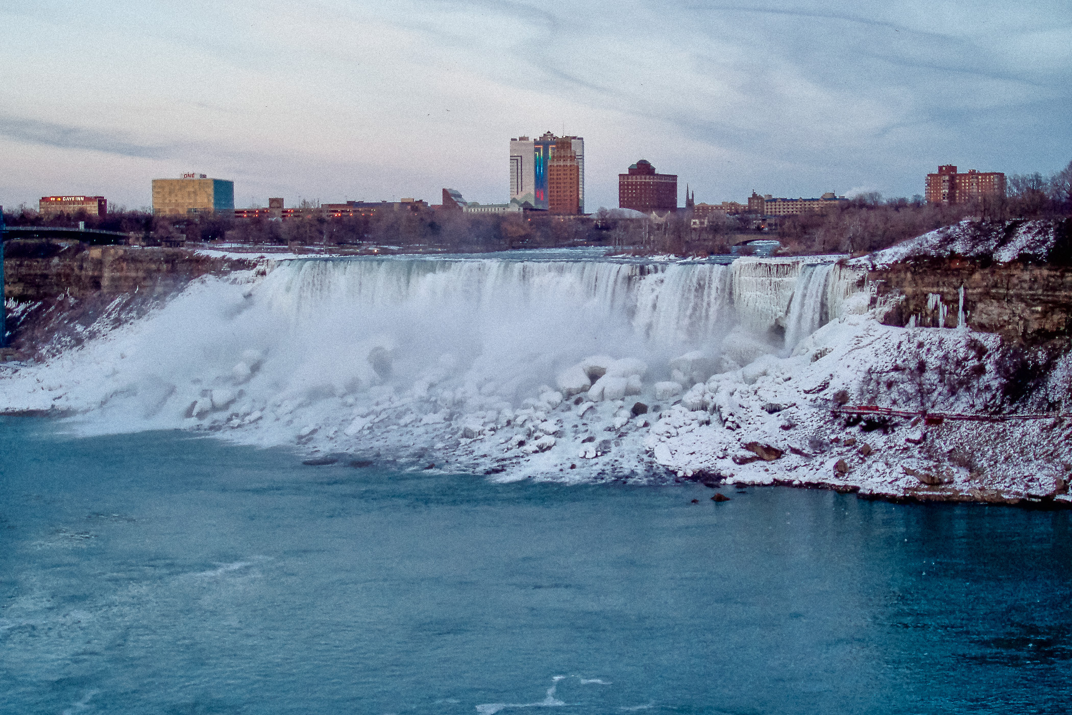 The American Falls at Niagara Falls as seen from the Canadian side of the border on a cold winter evening.