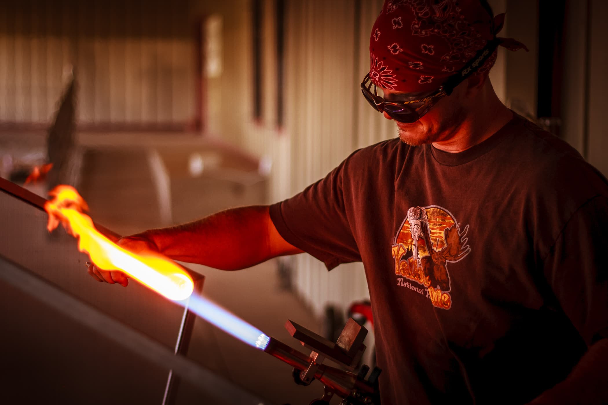 An artisan shapes molten glass at the Vetro Glass Studio in Grapevine, Texas.
