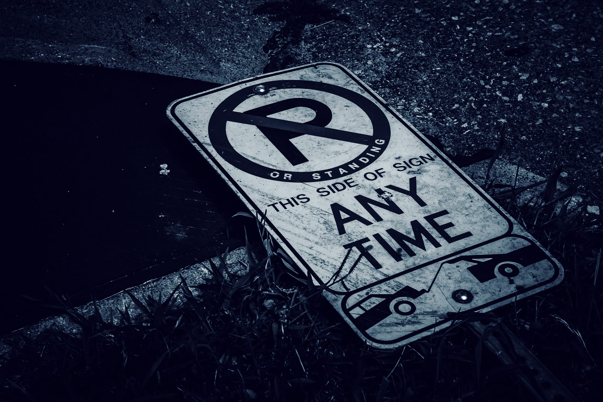 A fallen no parking sign spotted along a road in Uptown Dallas, Texas.