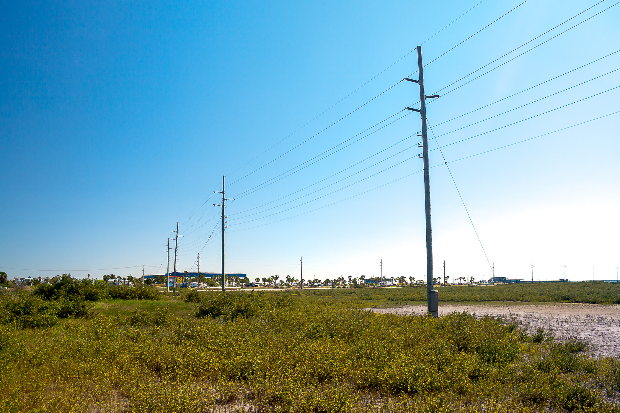 Power lines lead to a lonely convenience store on South Padre Island, Texas.