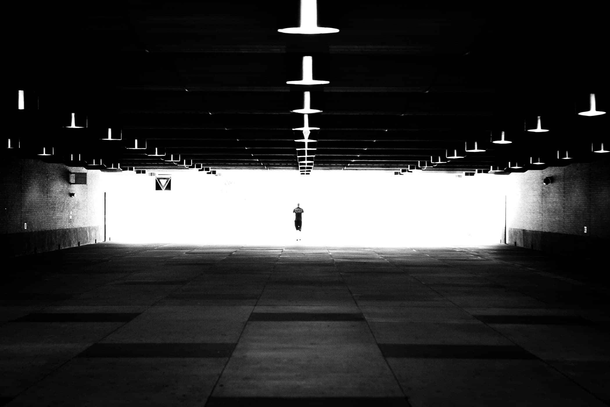 A lone figure traverses the tunnel under Wellborn Road from Texas A&M University's Main Campus to its West Campus.