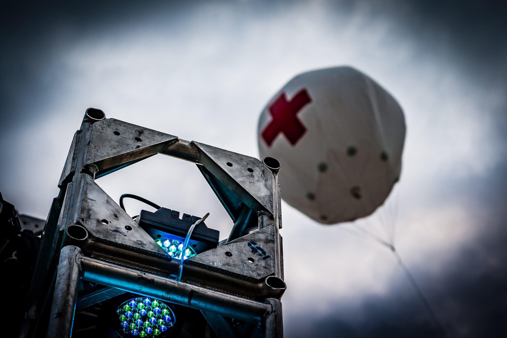 A lighting truss and a balloon marking the first aid station at the Plano Balloon Festival, Texas.