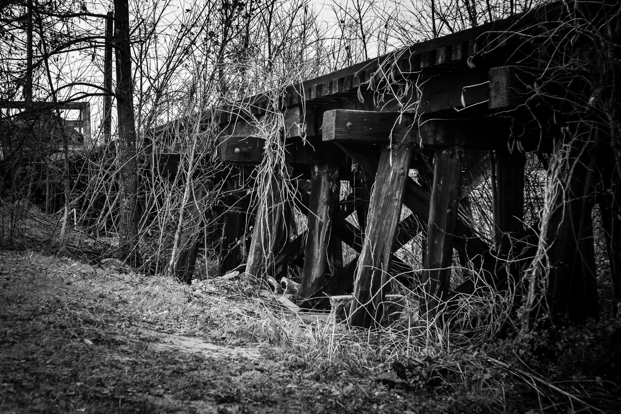 An abandoned and decaying railroad bridge in Jefferson, Texas.