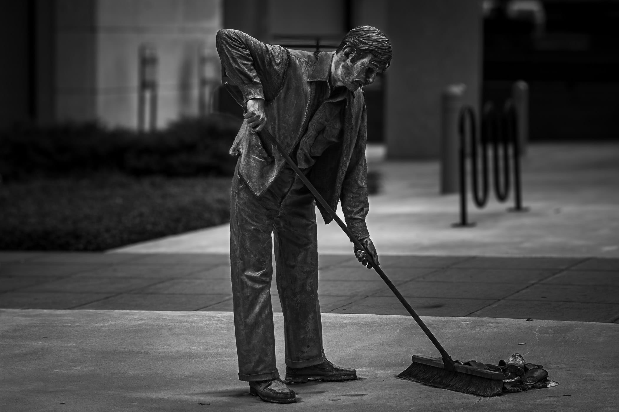John Seward Johnson, Jr.'s sculpture Aftermath of a custodian sweeping up trash in Downtown Dallas.