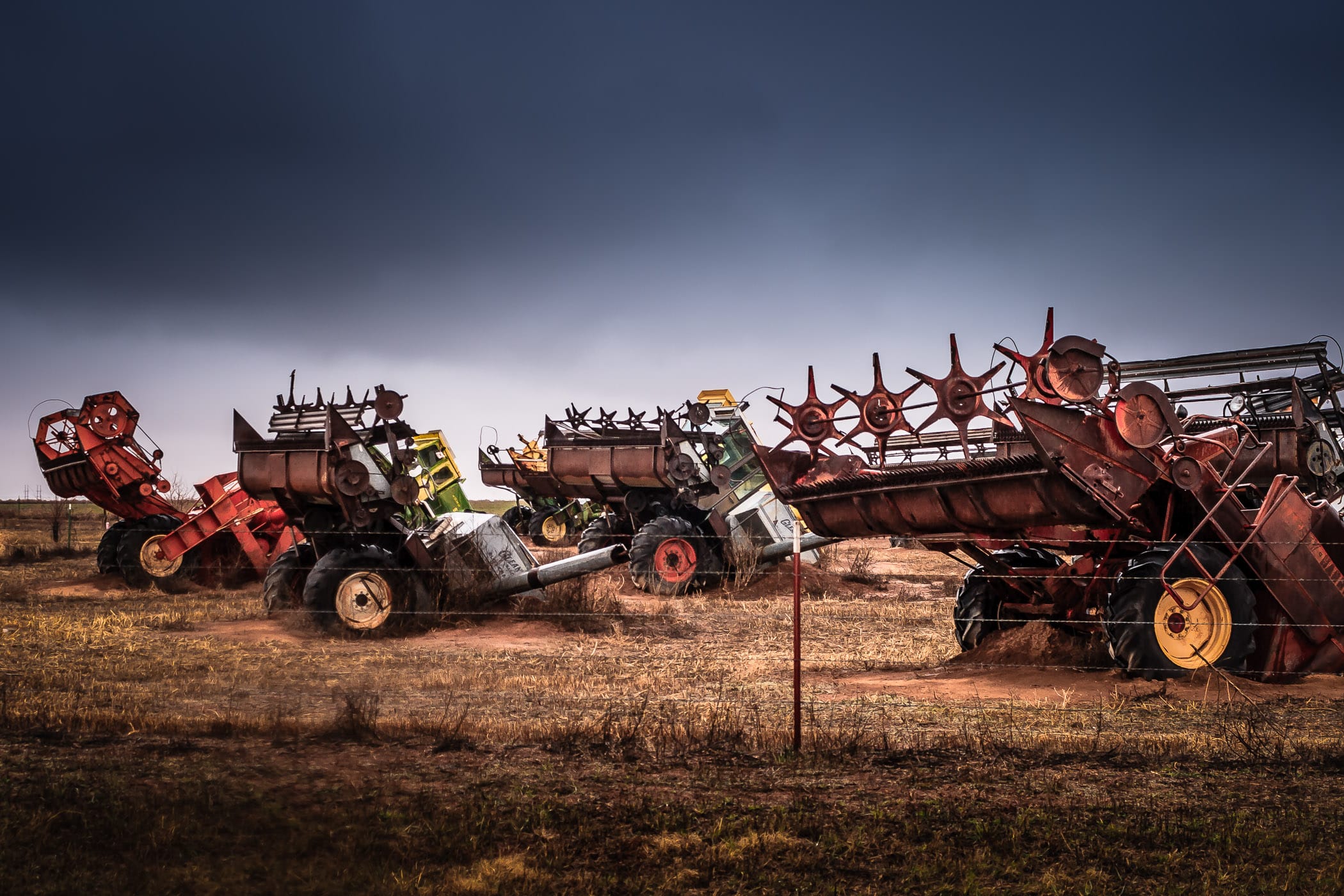 A portion of Combine City—over a dozen combine harvesters buried "nose-first" in a field—outside of Canyon, Texas.