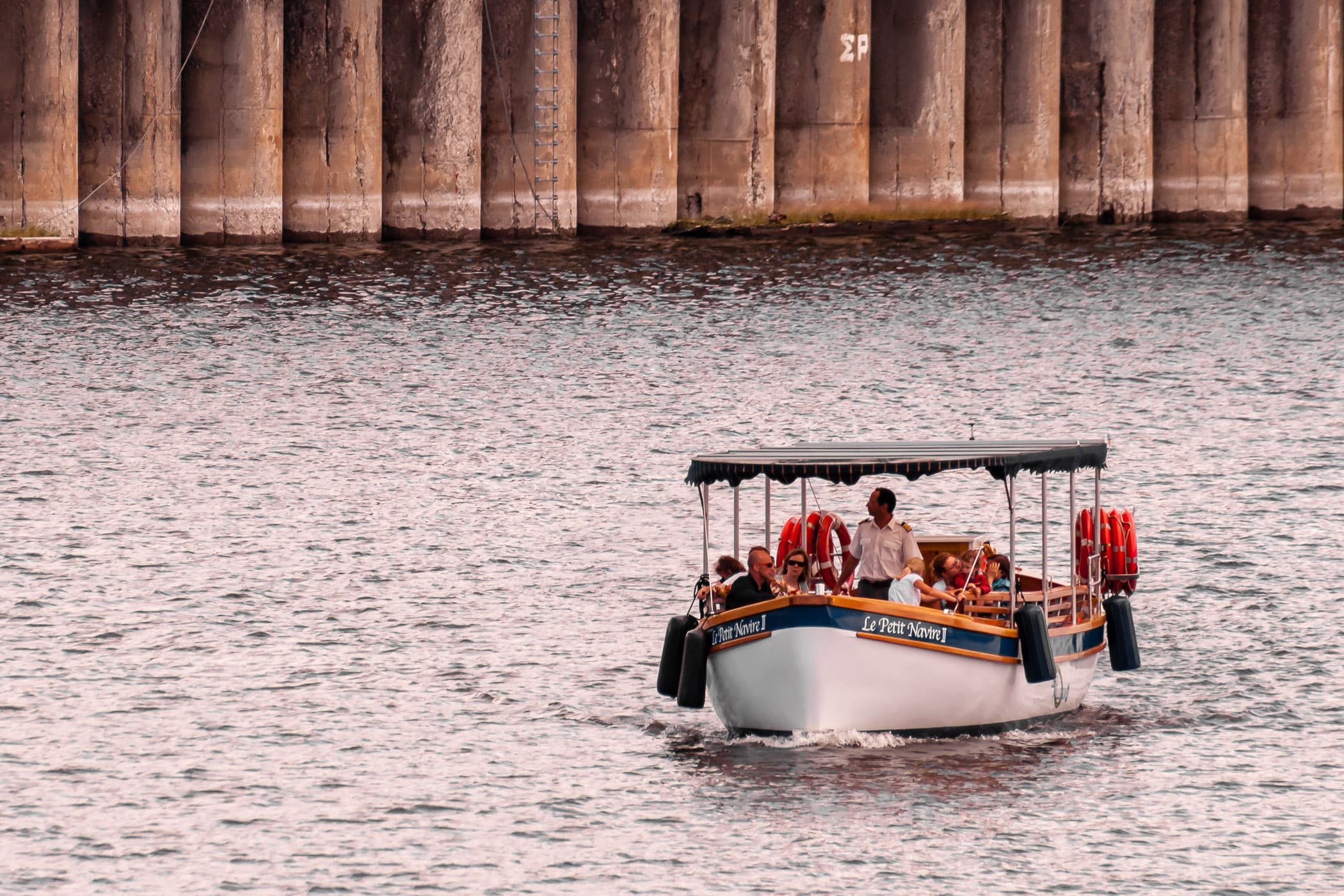 A sightseeing boat navigates the quays of Montréal's Vieux-Port.