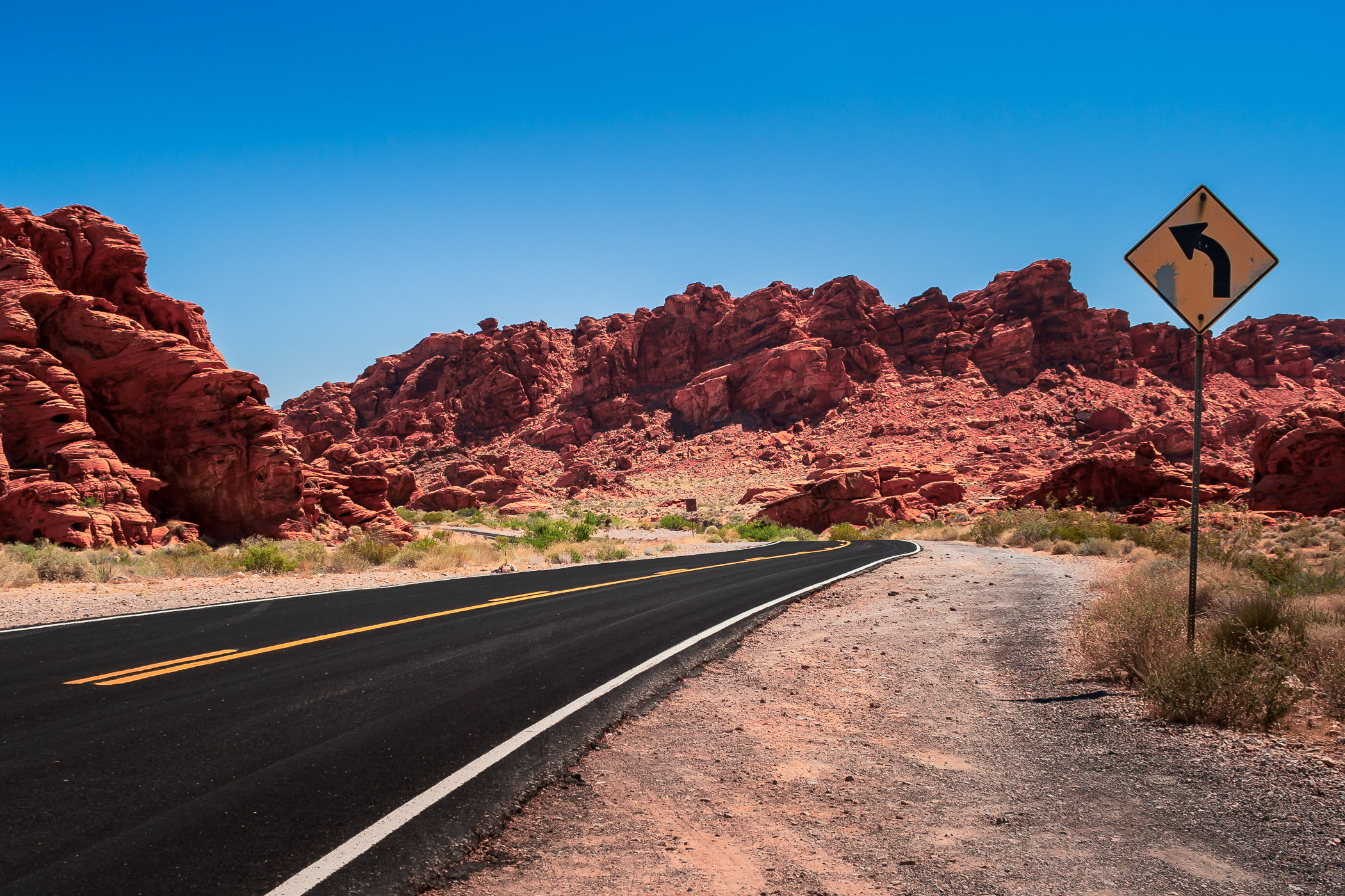 A desert road winds through the rocky landscape of Valley of Fire, Nevada.