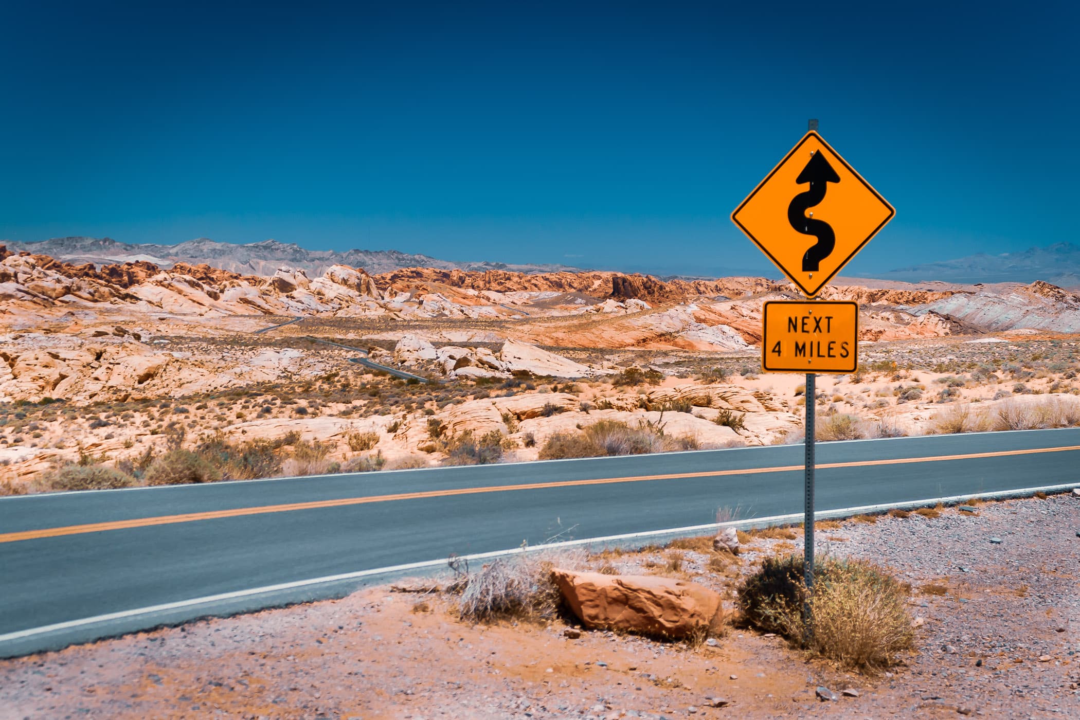 A road sign warning of curves ahead in the Nevada desert somewhere east of Las Vegas near Lake Mead near Hoover Dam.