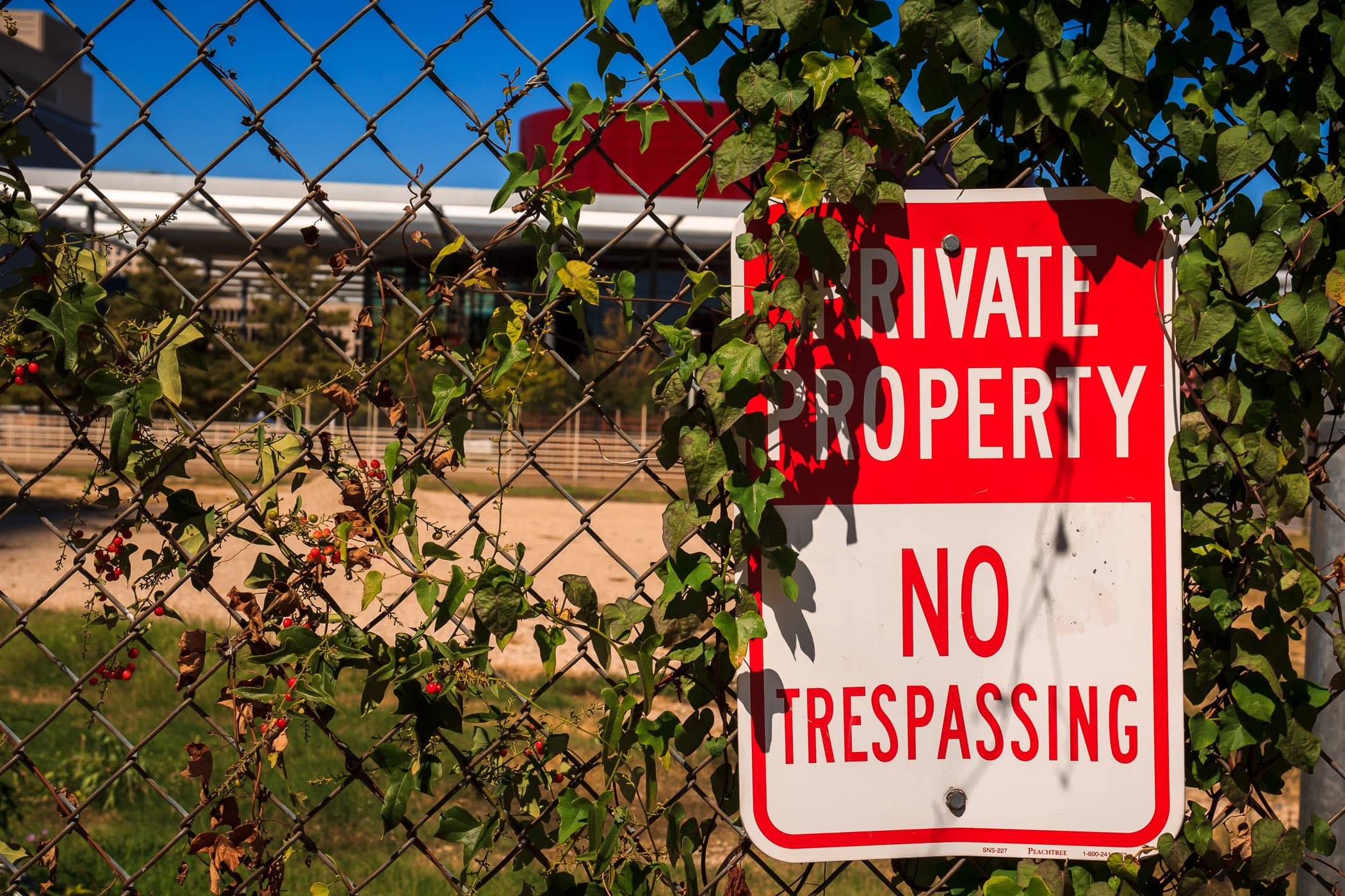 A fenced-off lot in the Dallas Arts District, behind which can be seen the Winspear Opera House.