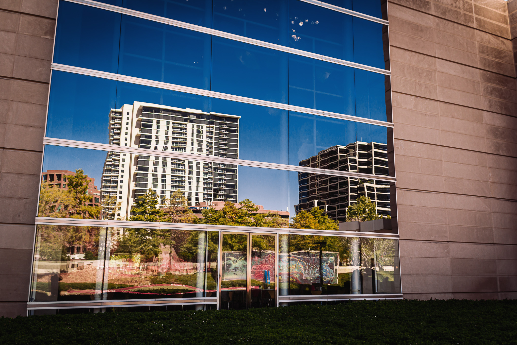Buildings in Uptown Dallas reflected in windows of the Dallas Museum of Art.