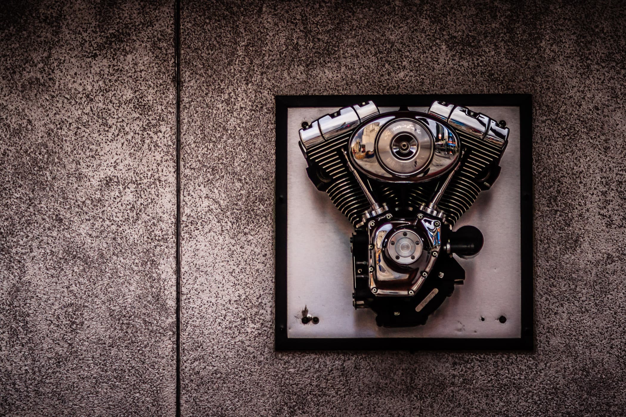A V-Twin motorcycle engine mounted on a wall outside of the Harley-Davidson Cafe in Las Vegas.