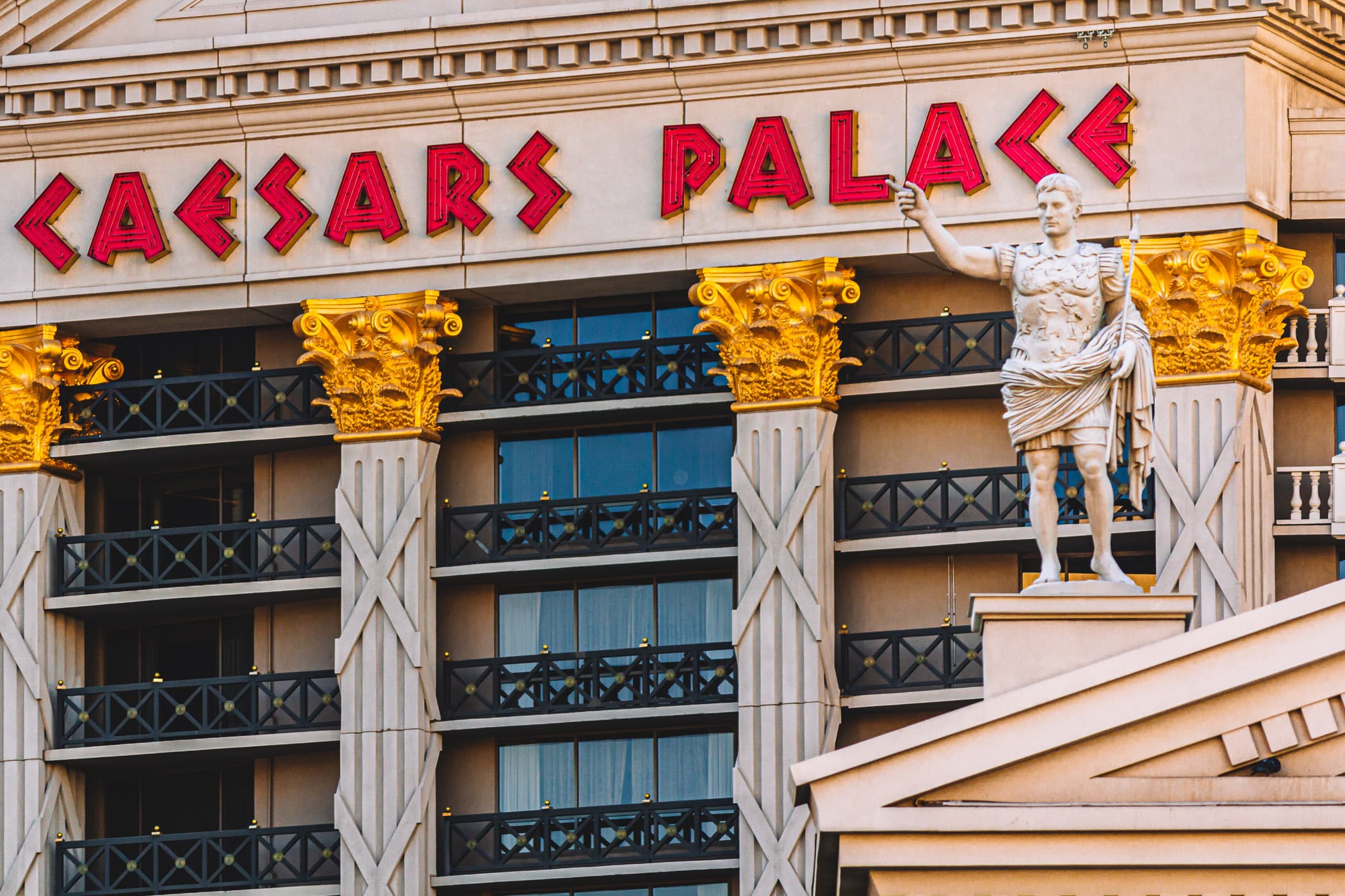 A statue outside of Las Vegas' Caesars Palace seems to point at the resort's sign on one of its guest room towers.