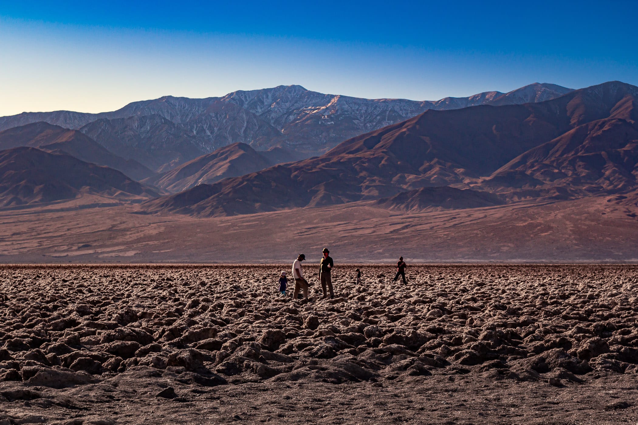 Tourists at The Devil's Golf Course, Death Valley, California.