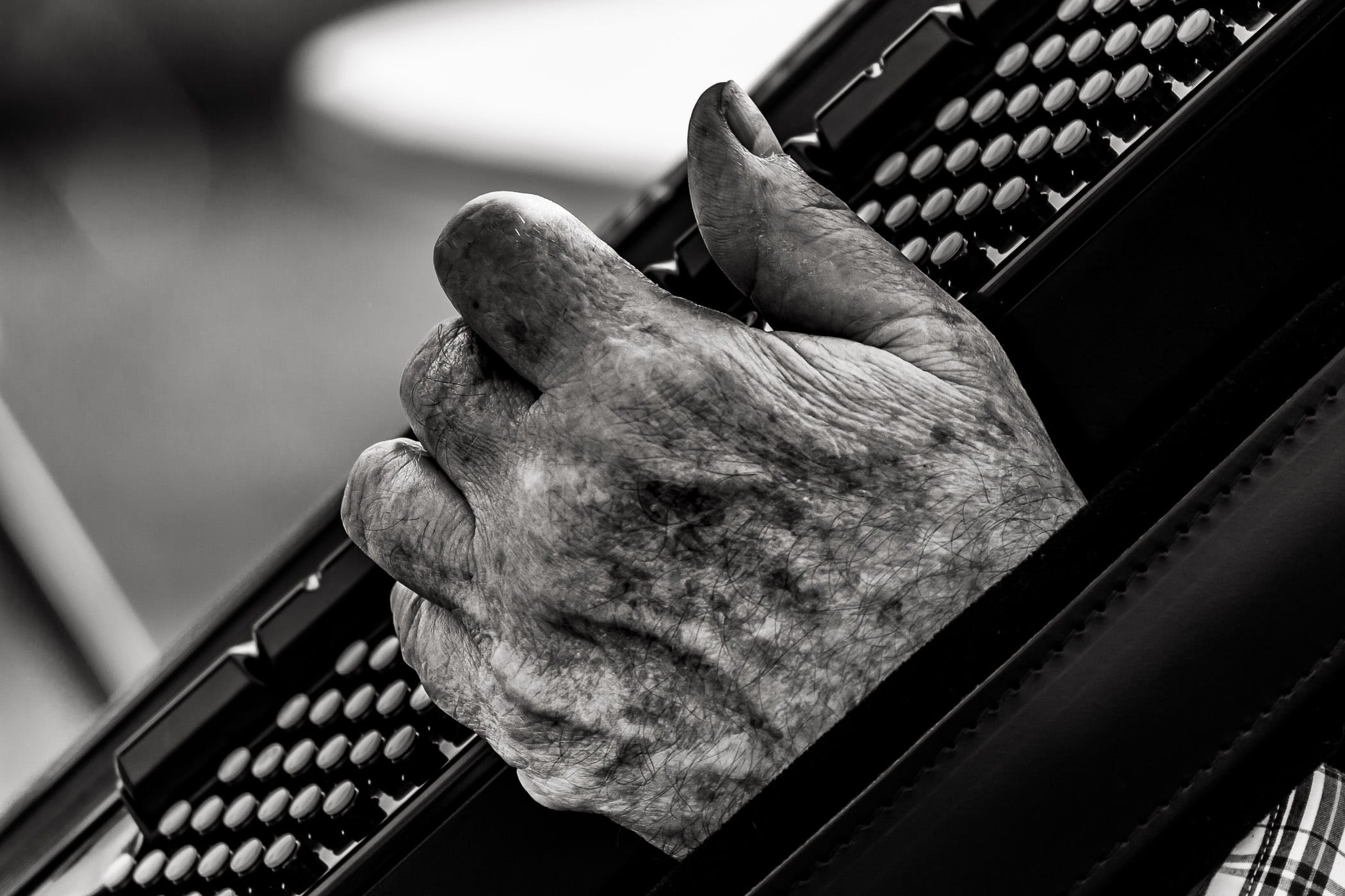 The aged hand of an accordion player at Addison Oktoberfest, Addison, Texas.
