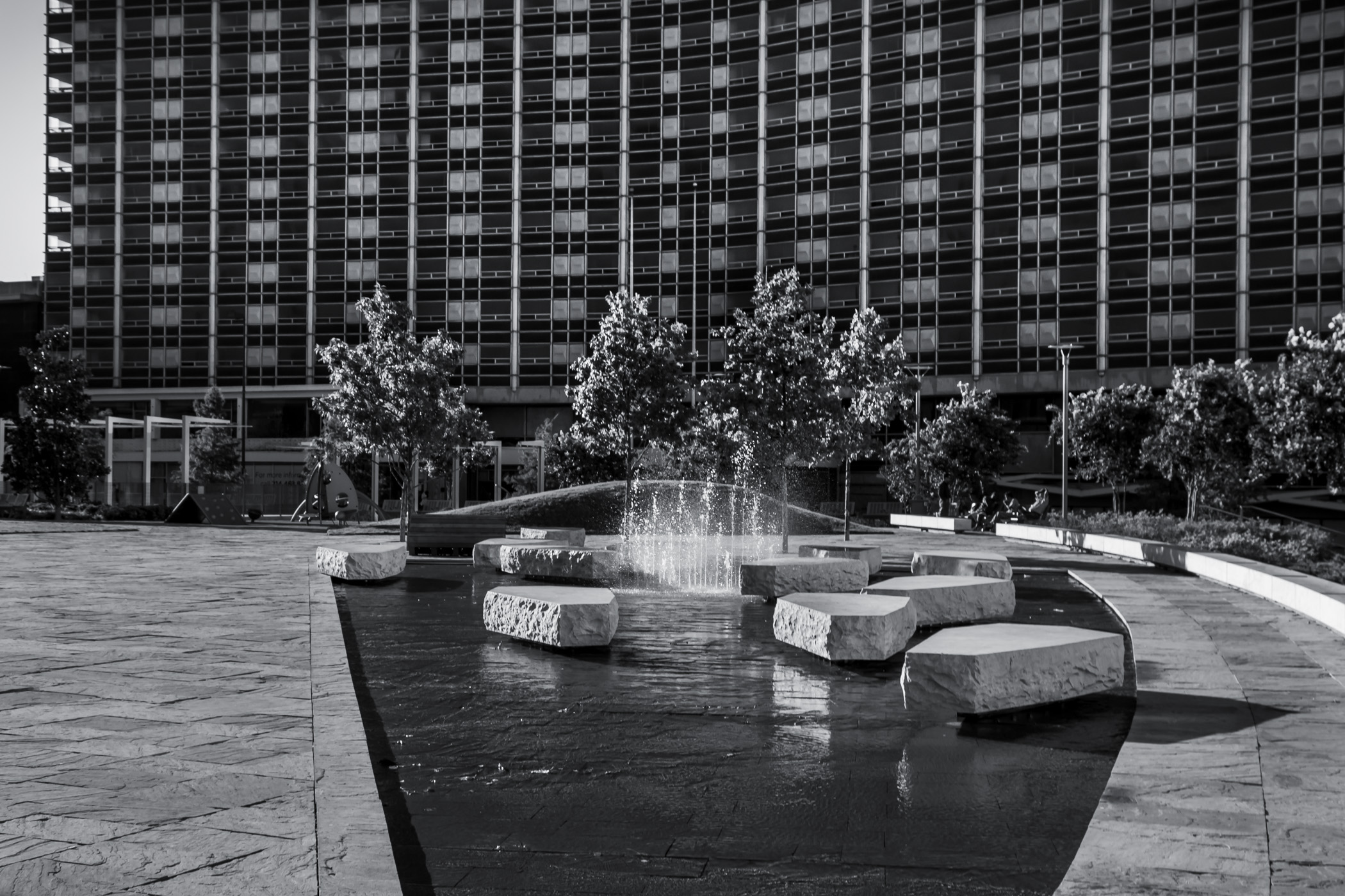 The long-abandoned yet soon-to-be-reborn Dallas Grand Hotel (formerly known as the Statler Hilton) looms over Main Street Garden in Downtown Dallas.