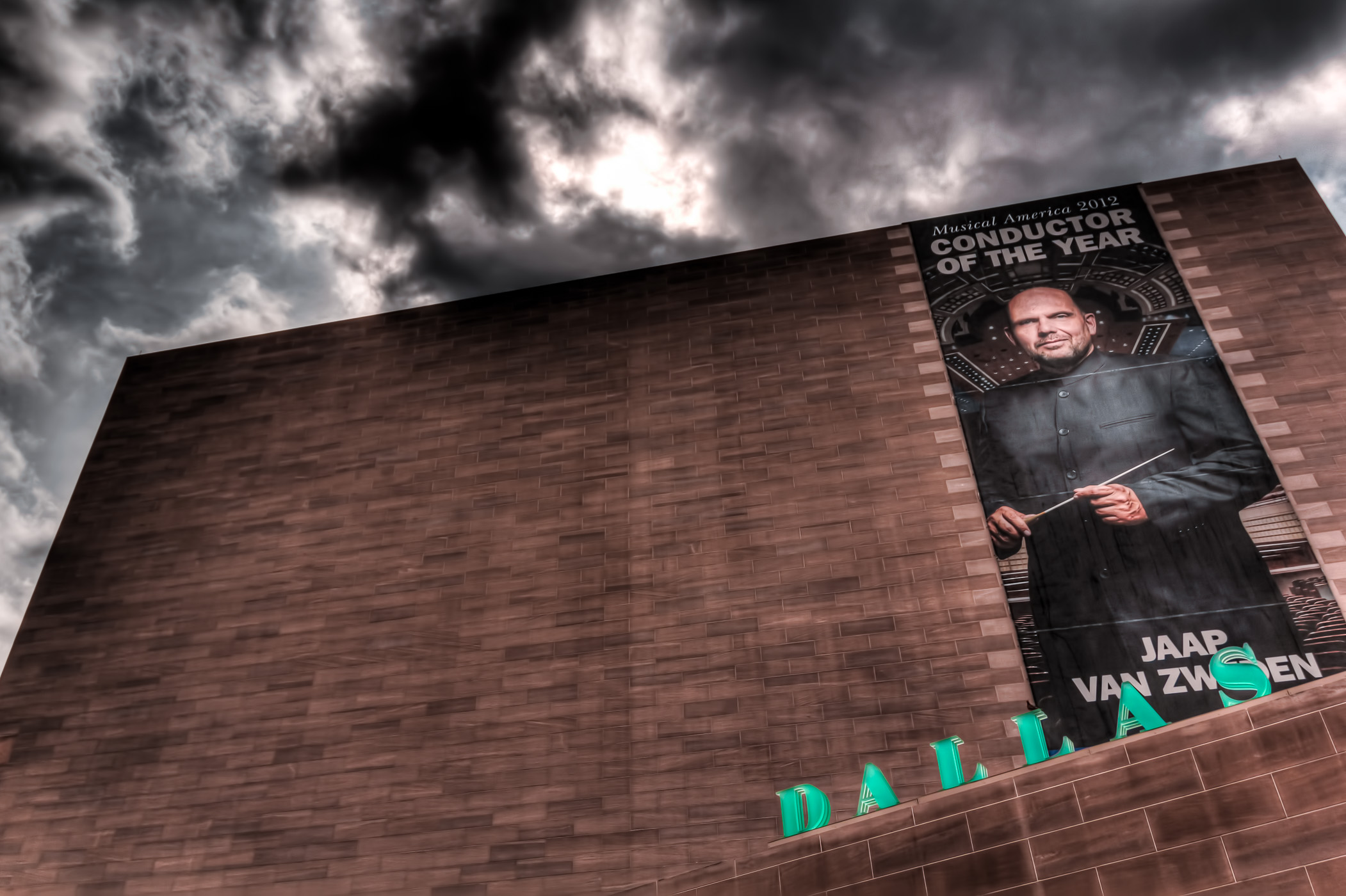 A banner featuring the Dallas Symphony Orchestra's conductor, Jaap Van Zweden, on the exterior of the I.M. Pei-designed Meyerson Symphony Center.