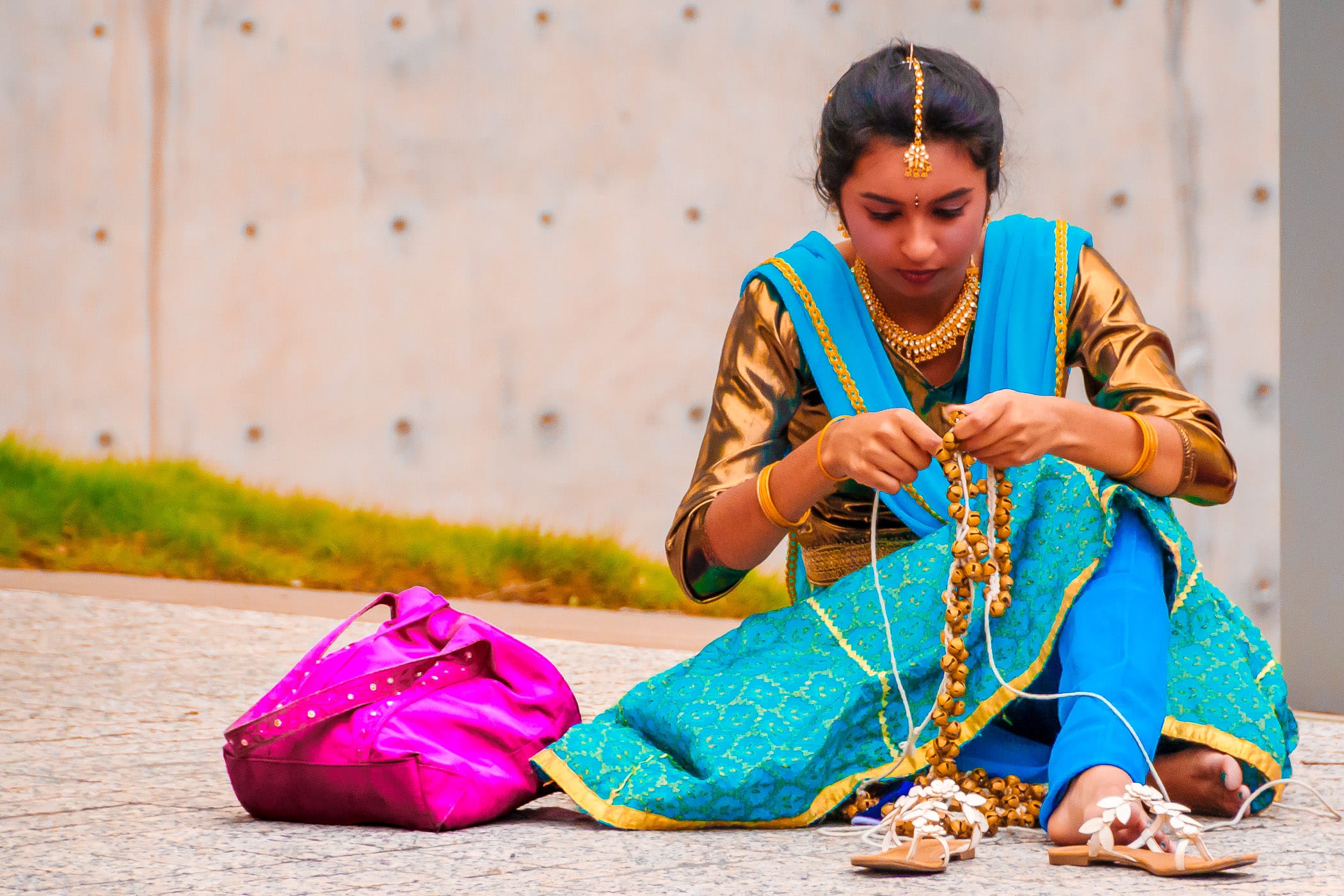 A dancer at the Dallas International Festival prepares her accoutrements before performing.