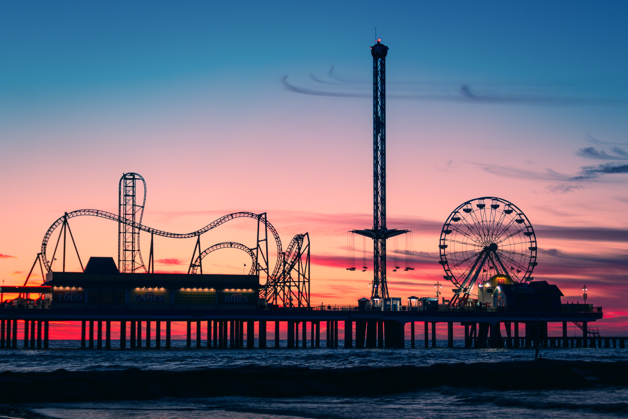 Galveston, Texas' Historic Pleasure Pier, silhouetted by the sunrise.