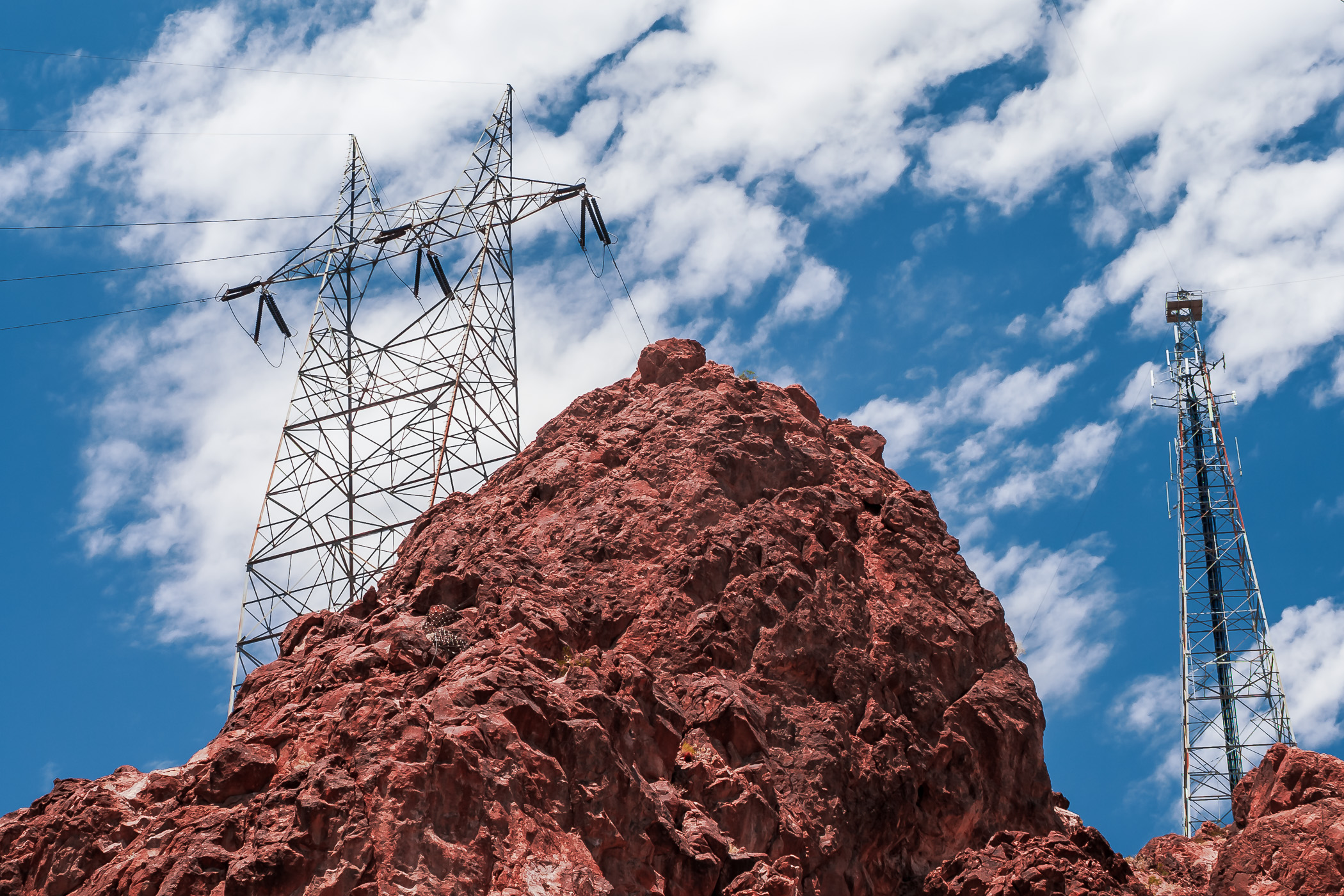 A power line pylon perched atop a rocky outcropping near Hoover Dam, on the Nevada/Arizona border.