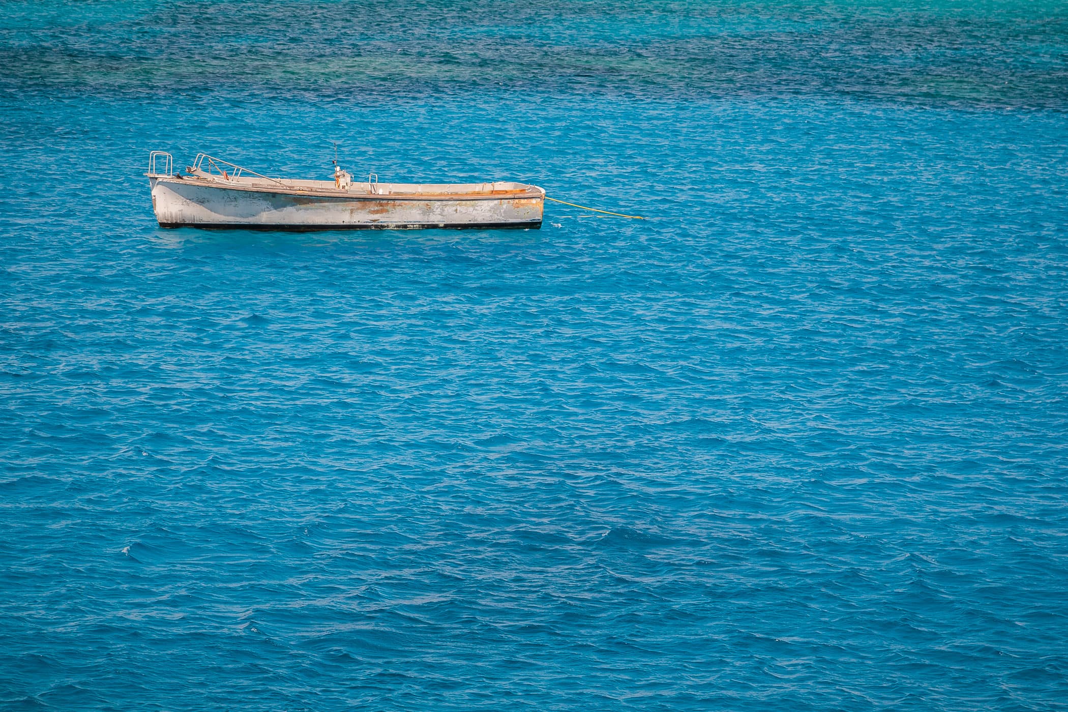 A boat floats in the Caribbean Sea just off the coast of George Town, Grand Cayman.