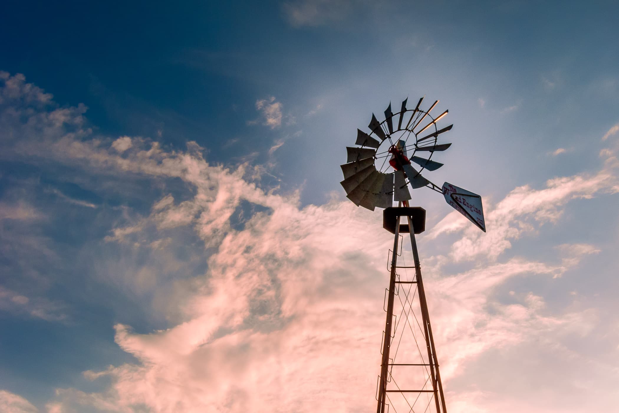 A windmill is backlit by the setting sun at the Addison Conference Centre in Addison, Texas.