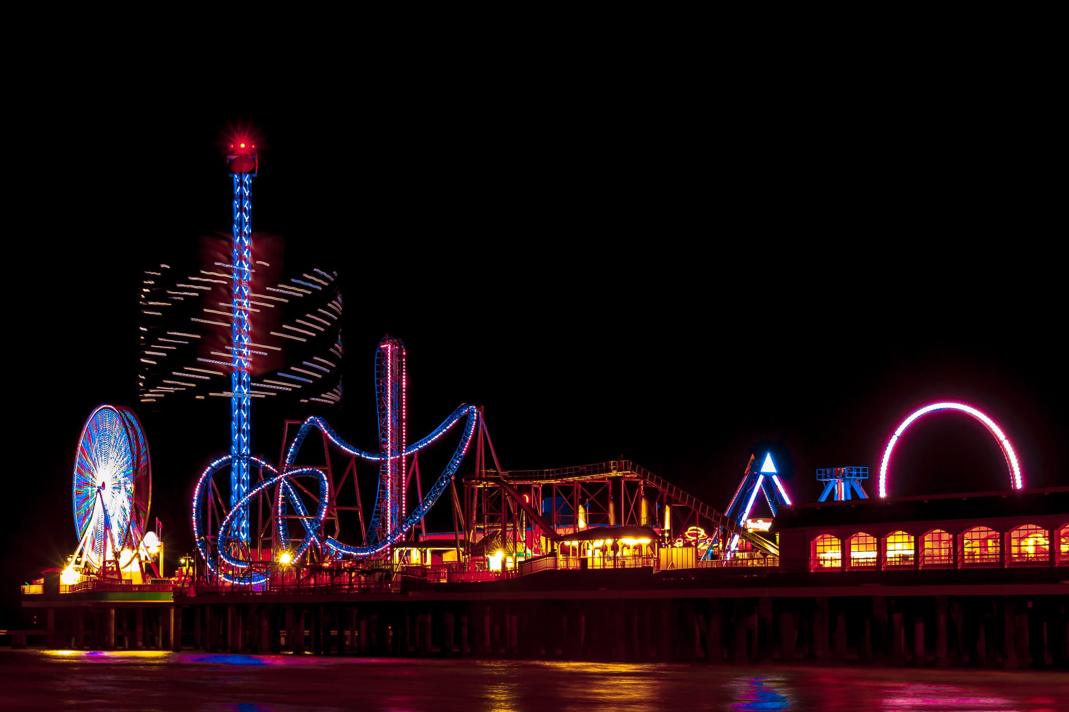 A long-exposure shot of Galveston, Texas' Pleasure Pier at night.