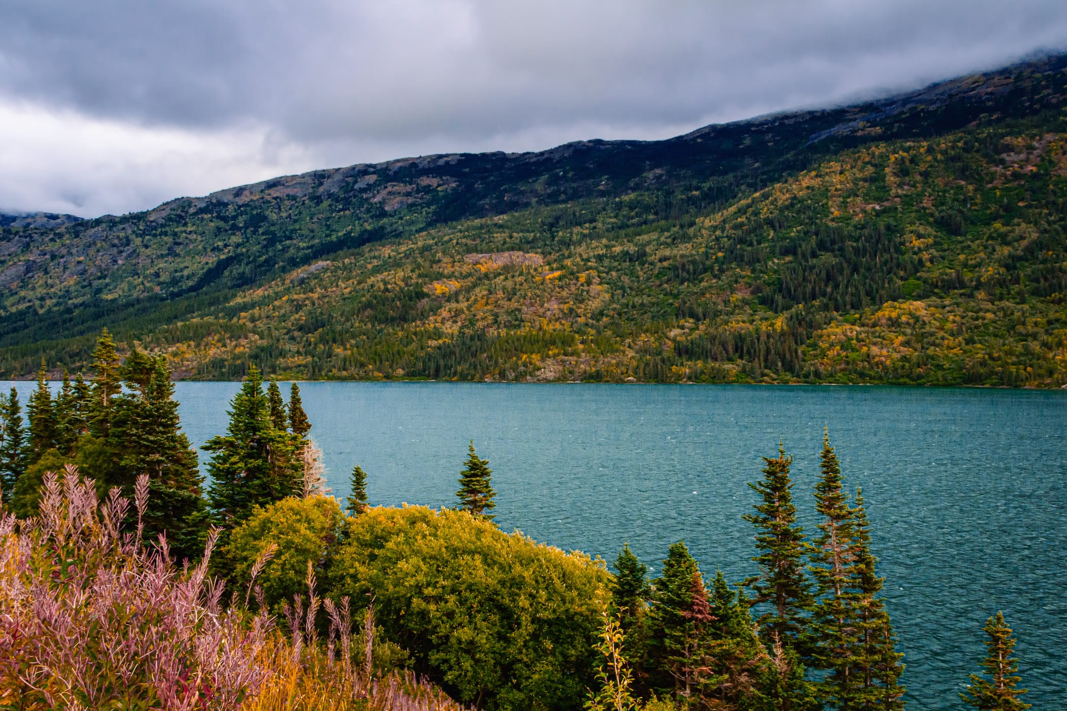 Storm clouds begin to form over Tutshi Lake in the low mountains near Carcross, Yukon Territory, Canada.