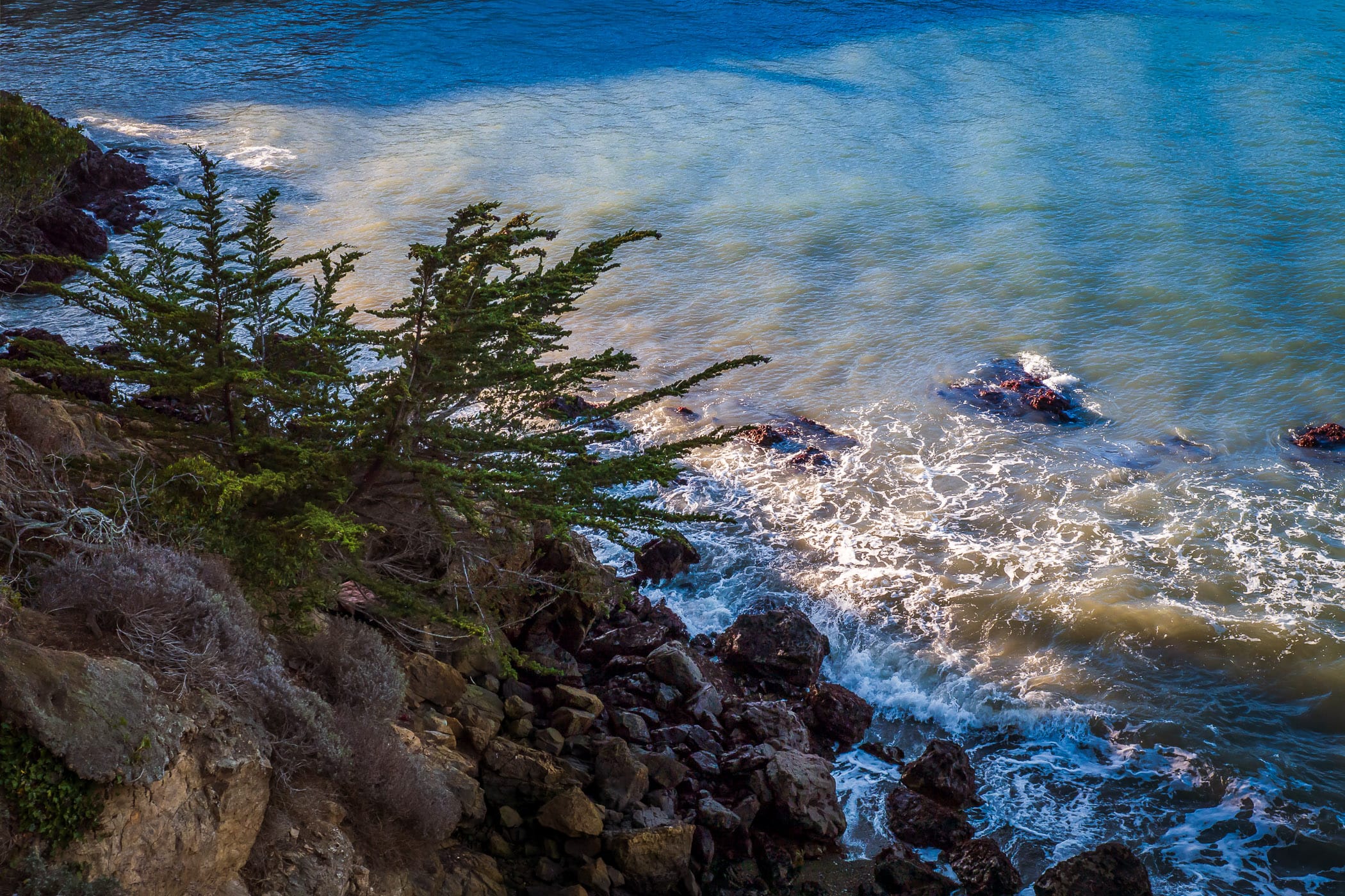 Waves in San Francisco Bay crash into the rocks at Black Point near Fort Mason National Park.