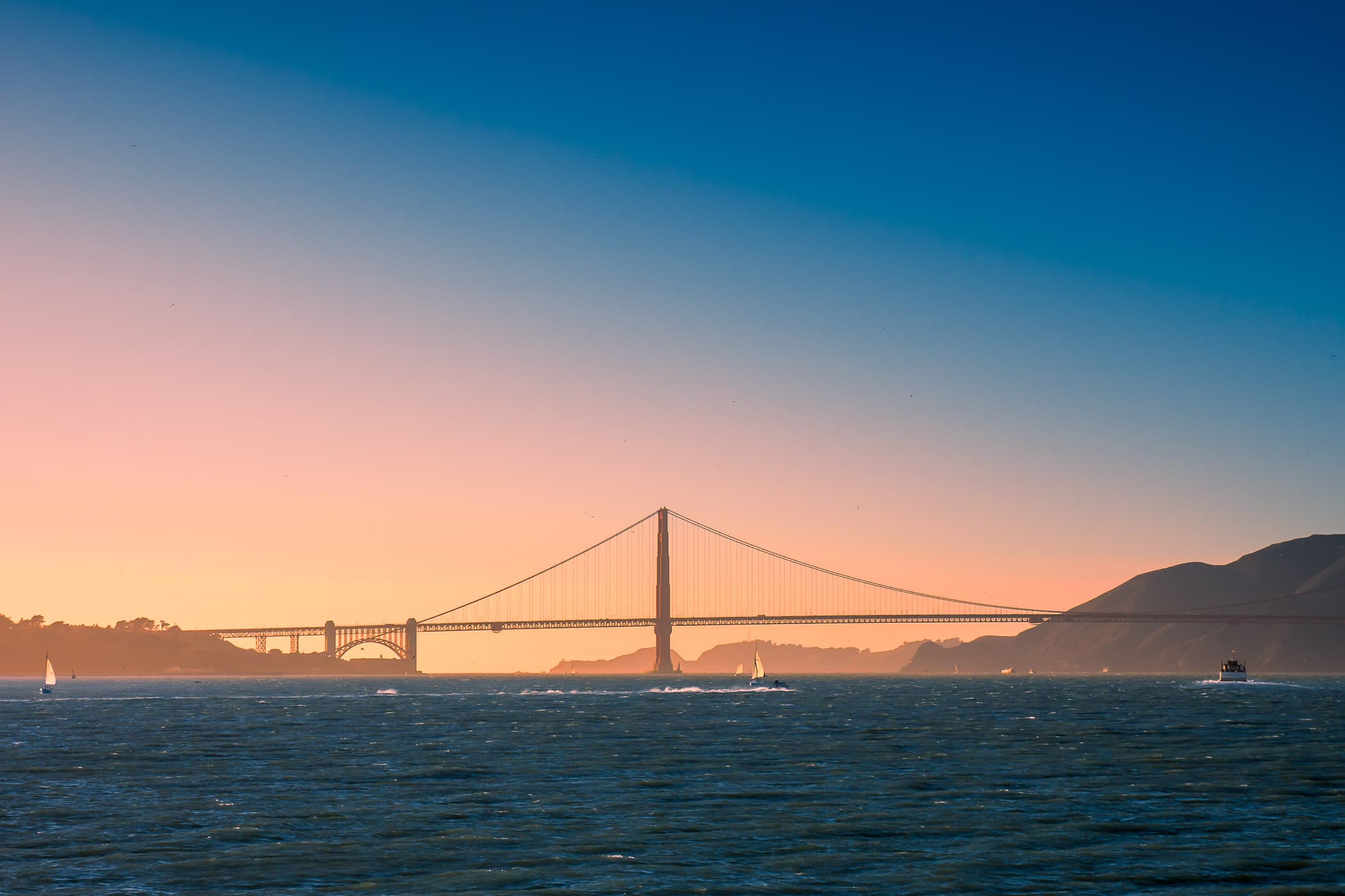 The early evening sun lights the south tower of San Francisco's iconic Golden Gate Bridge.