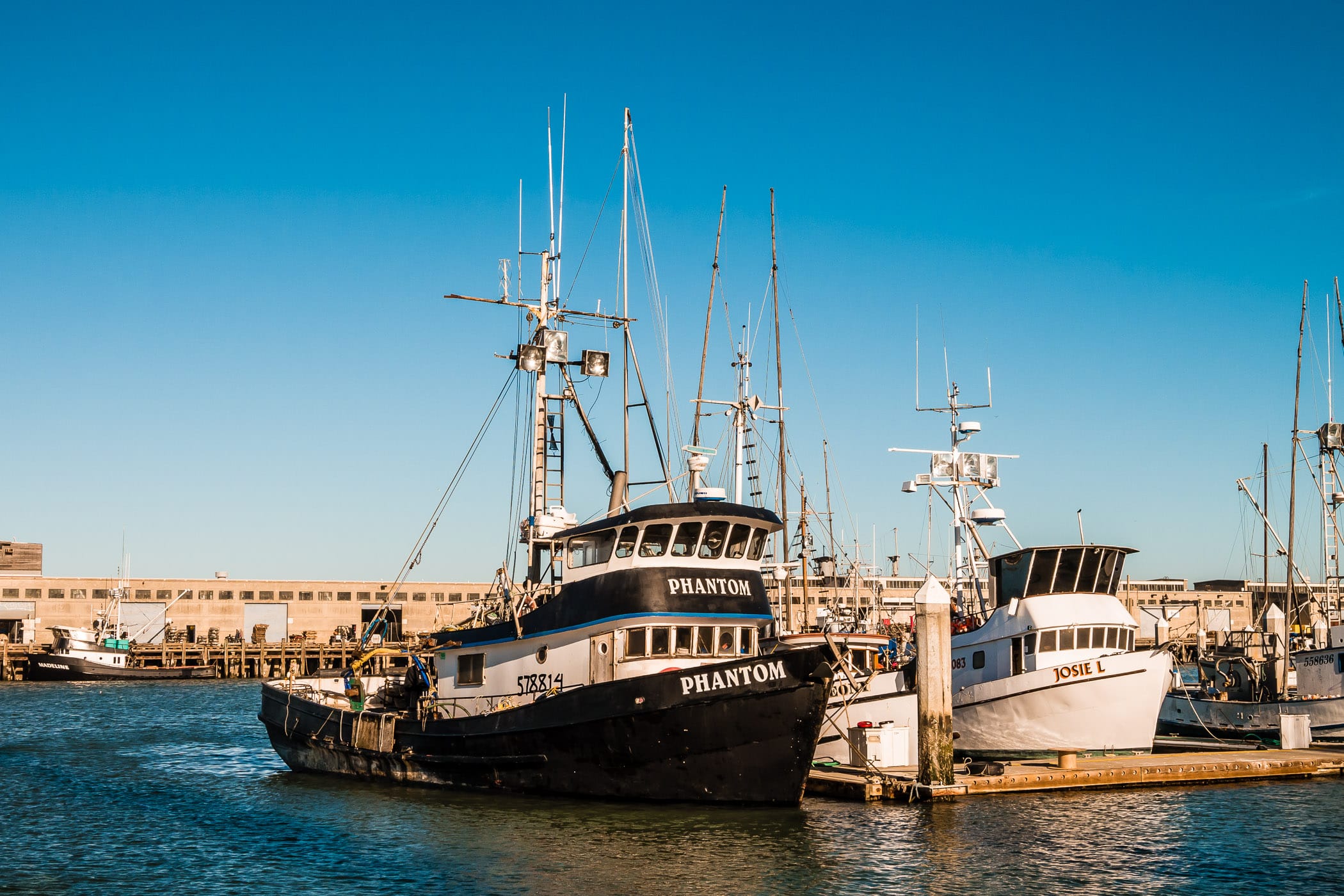 Boats docked at a pier along San Francisco's Fisherman's Wharf.