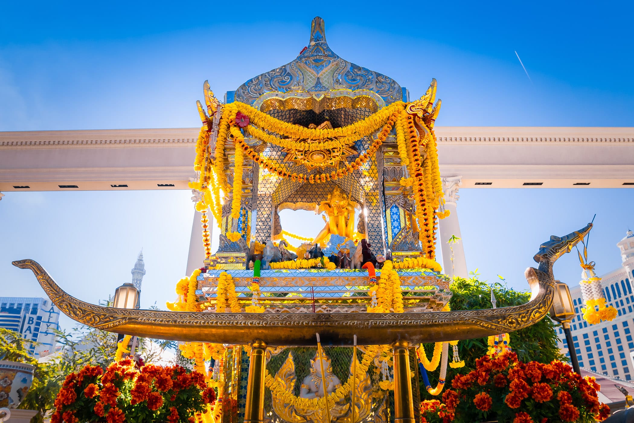 The Erawan Shrine (or Shrine of the Four-Faced Brahma) at Caesars Palace, Las Vegas, was built in 1984 and is a replica of the original in Bangkok, Thailand. It was donated by newspaper tycoons Mr. and Mrs. Kamphol Vacharaphol and Mr. Yip Hon, a prominent figure in Hong Kong and is considered a Hindu holy site. Visitors express gratitude for wishes granted by offering flowers, incense, money (which Caesars donates to charities in Thailand) or by placing small wooden elephants upon the shrine.