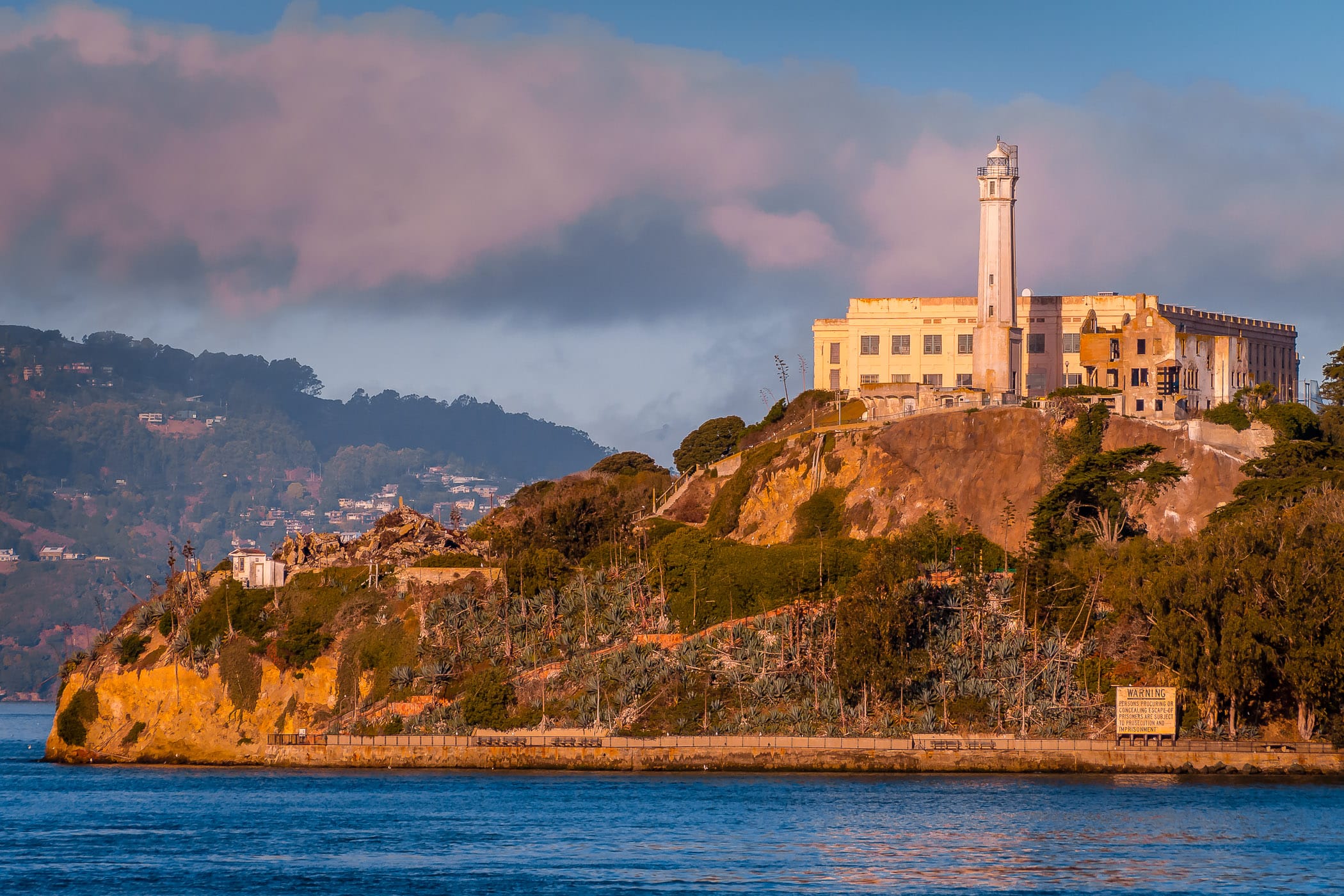 Alcatraz Federal Penitentiary rises from San Francisco Bay to catch the first light of the morning sun.