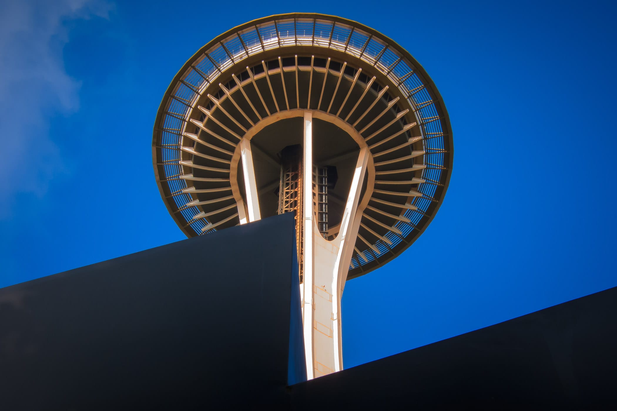 The iconic Space Needle rises into the clear blue sky over Seattle.