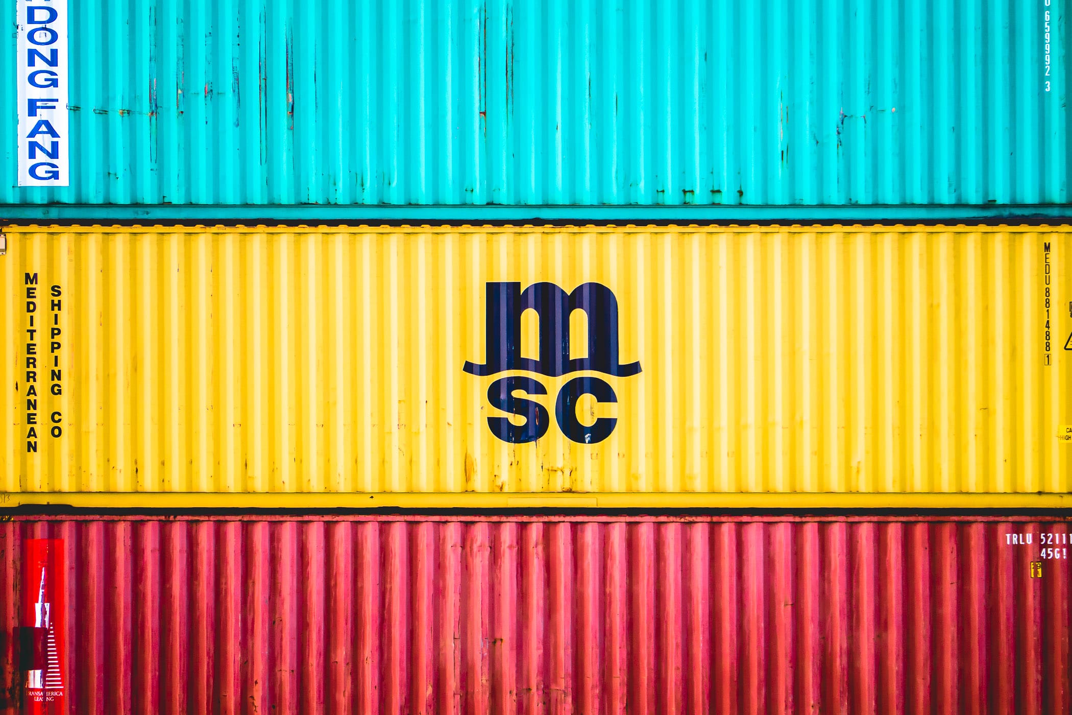 Multi-colored shipping containers of the Mediterranean Shipping Company sit stacked in a container yard in Freeport, Bahamas.