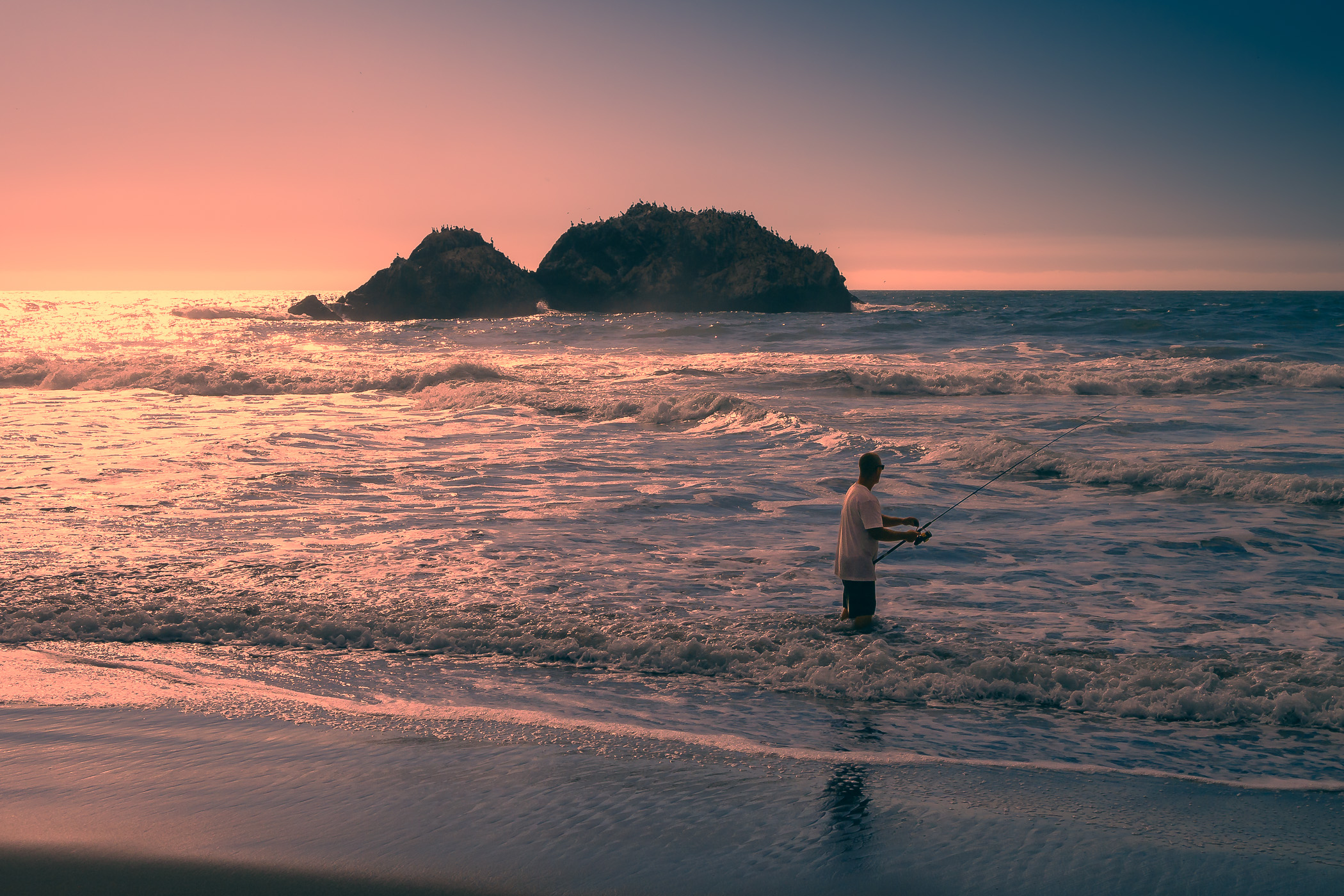 A fisherman tries his luck as the sun sets on the Pacific Ocean at San Francisco's Lands End.