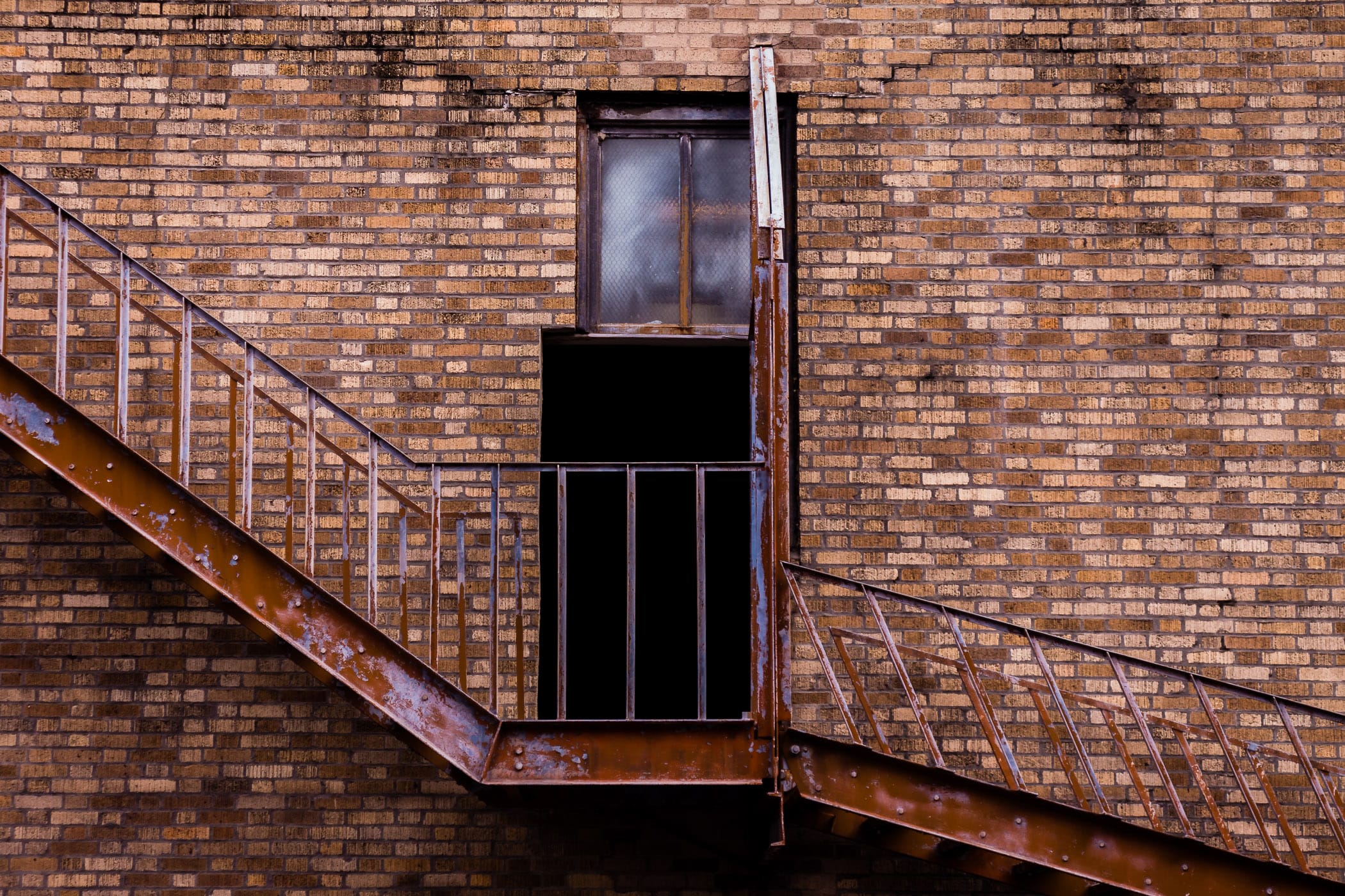 A doorway leads to a rusting fire escape at Downtown Houston's Great Southwest Building.