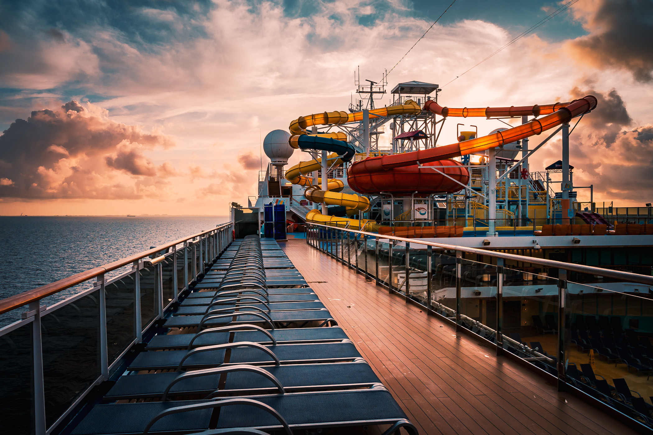 The Carnival Magic's onboard waterpark is backlit by the rising sun just off the coast of Freeport, Bahamas.