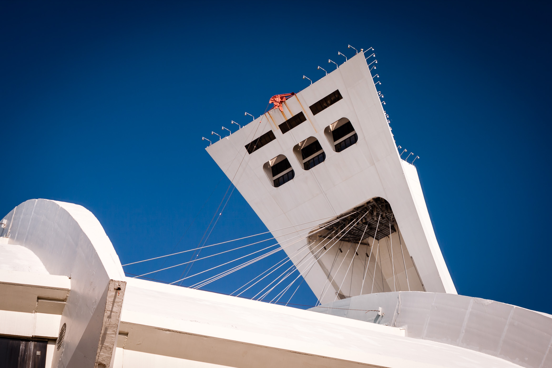 The 175-meter-tall (574 ft) tower at Montréal’s Olympic Stadium seems to peek over the structure's roofline.