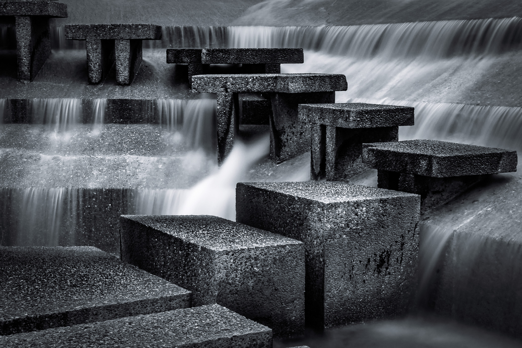 Water cascades around concrete steps at the Fort Worth Water Gardens.