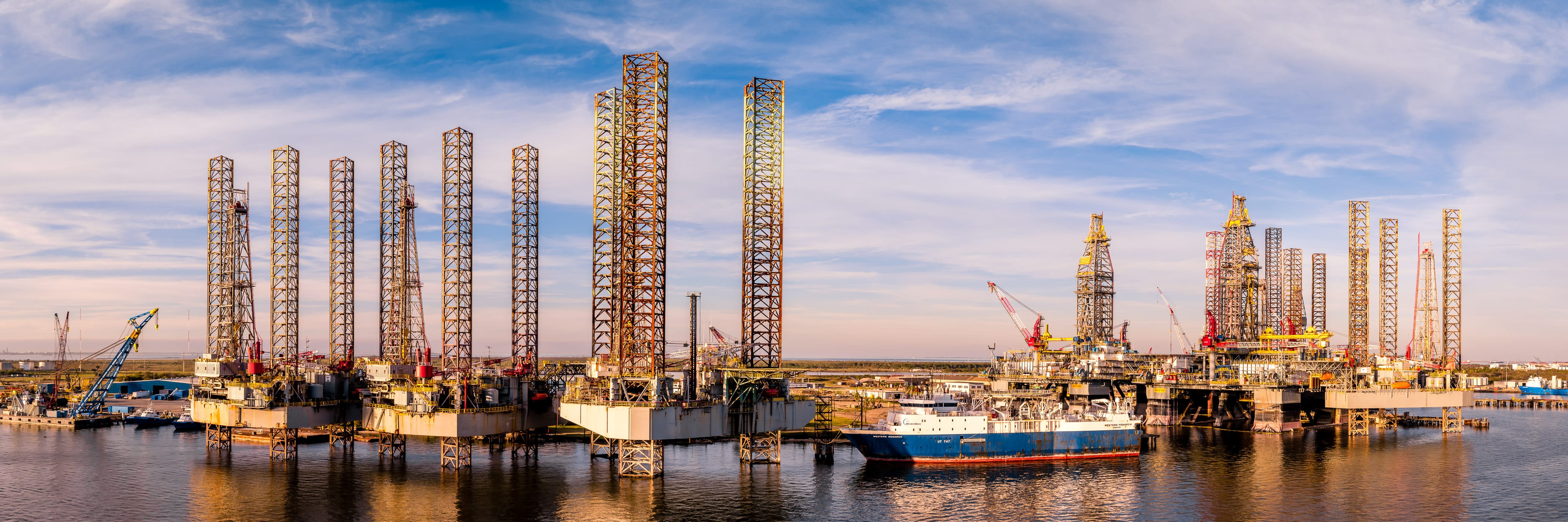 Long-legged oil platforms laid up for storage and repair at Pelican Island, Galveston, Texas. 
