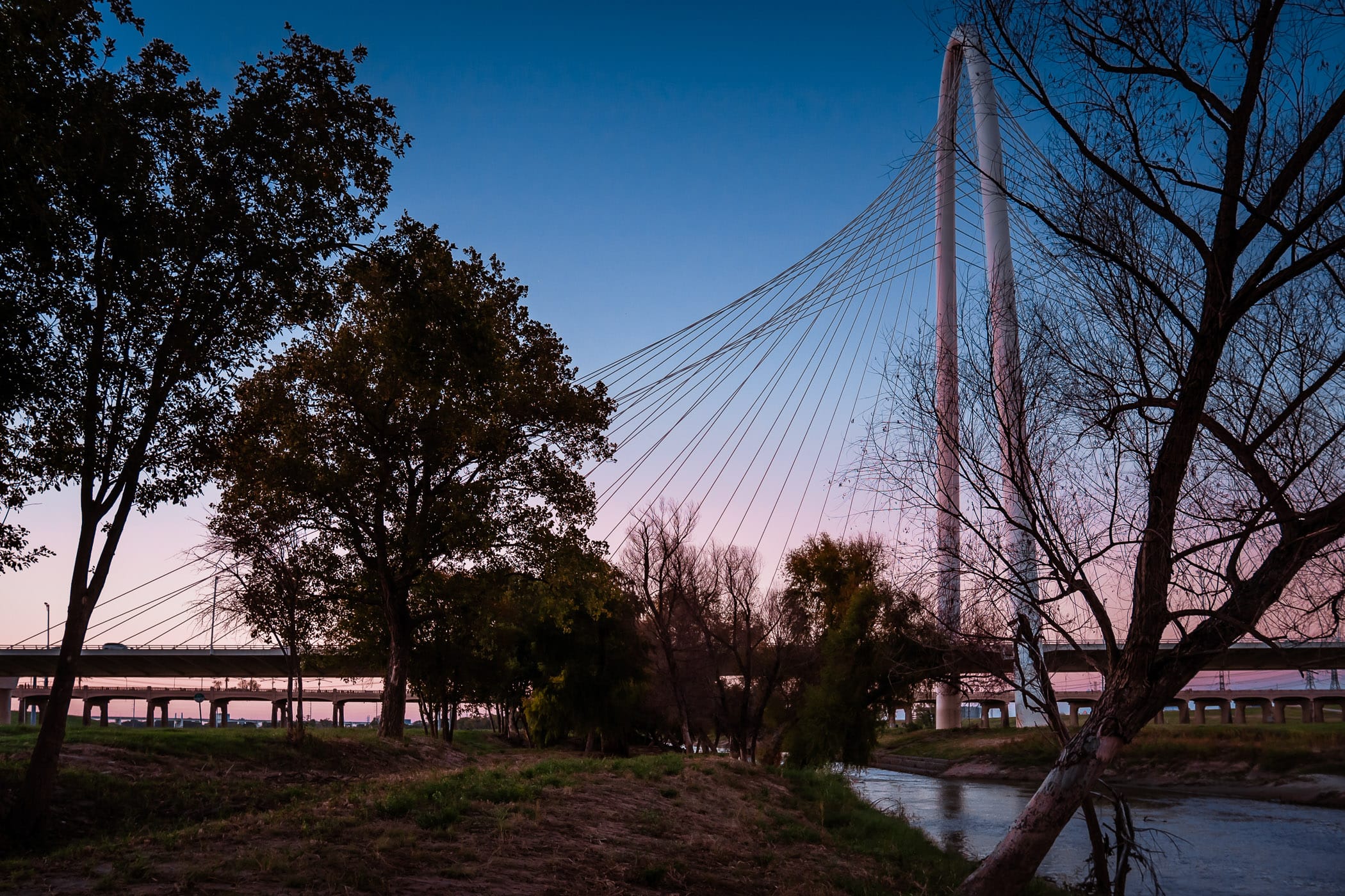 The sun sets on Dallas' Santiago Calatrava-designed Margaret Hunt Hill Bridge.