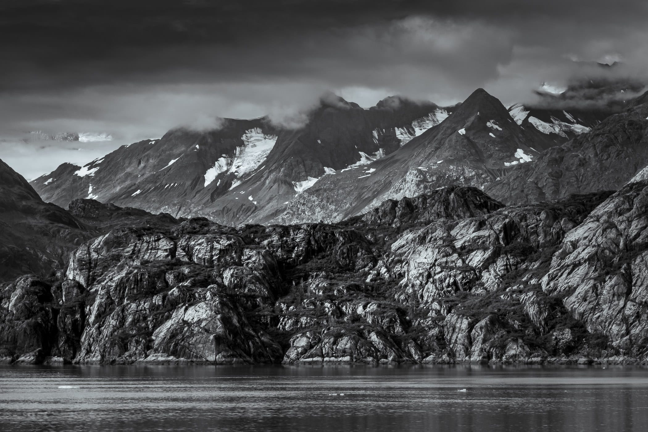 Clouds obscure the peaks of mountains in Alaska's Glacier Bay National Park.