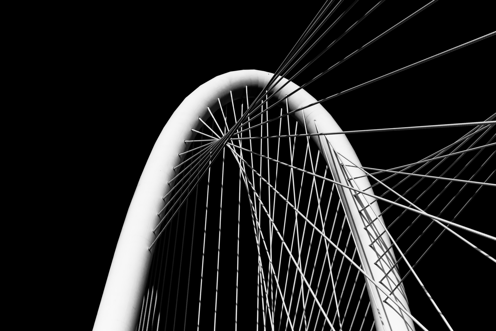 An abstract view of the arch and cables of the Santiago Calatrava-designed Margaret Hunt Hill Bridge in Dallas.