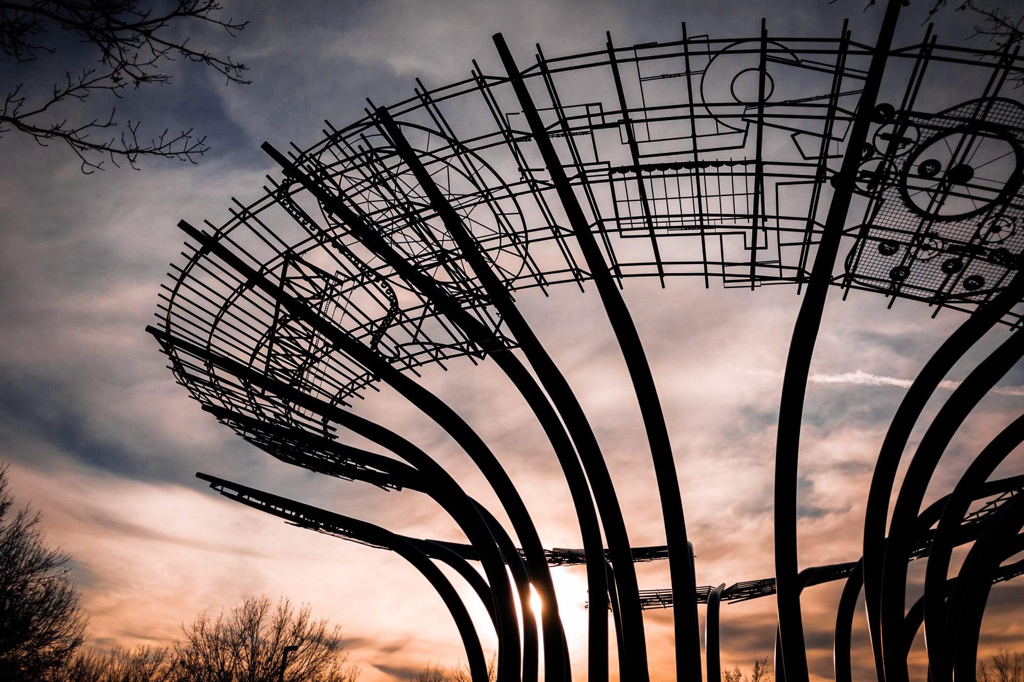 The sun sets on the 45-foot-tall, 140-foot-wide Blueprints sculpture at Addison Circle in Addison, Texas.