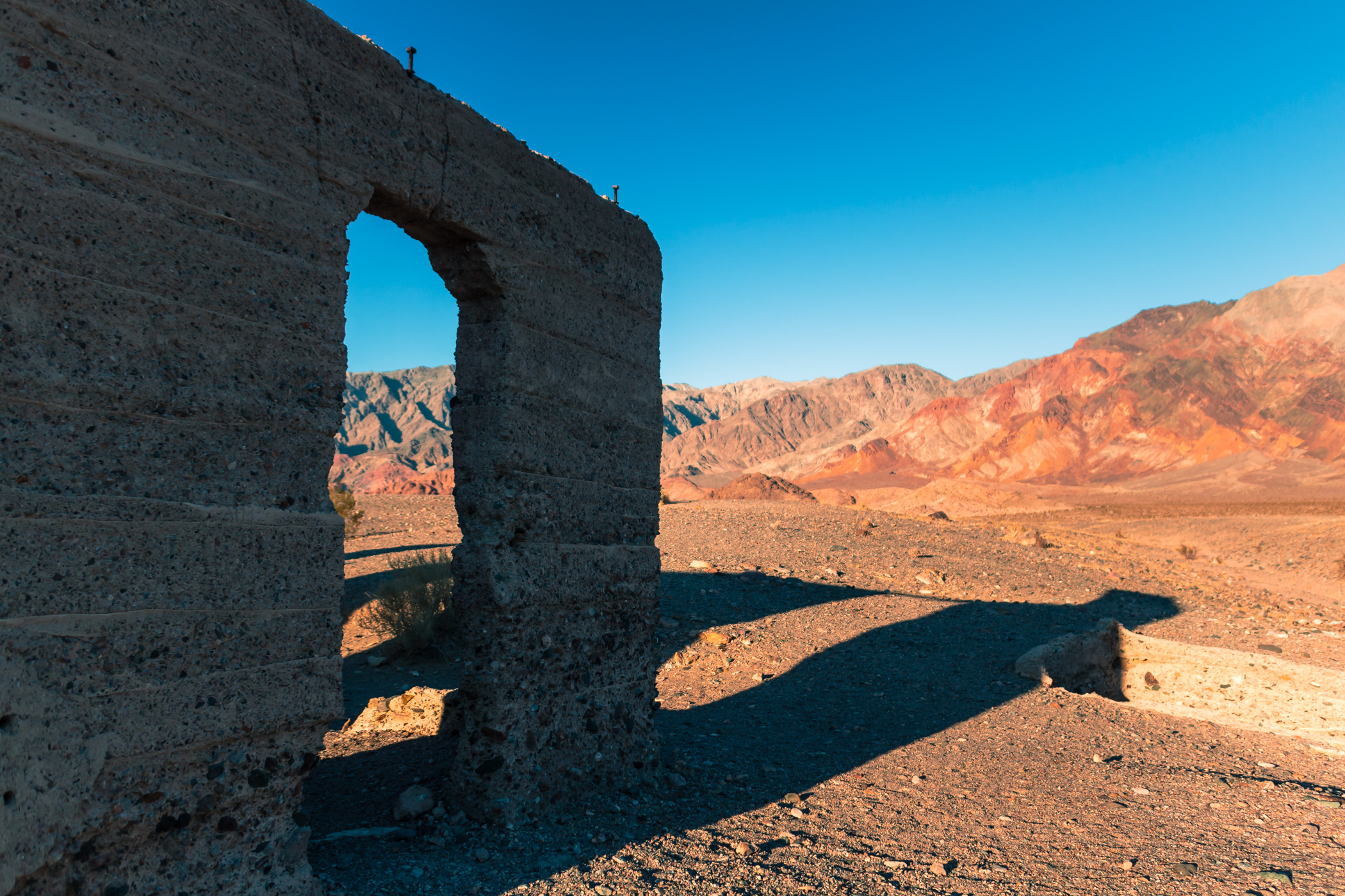 The Ashford Mill ruins cast long shadows in the dry desert at California's Death Valley National Park.